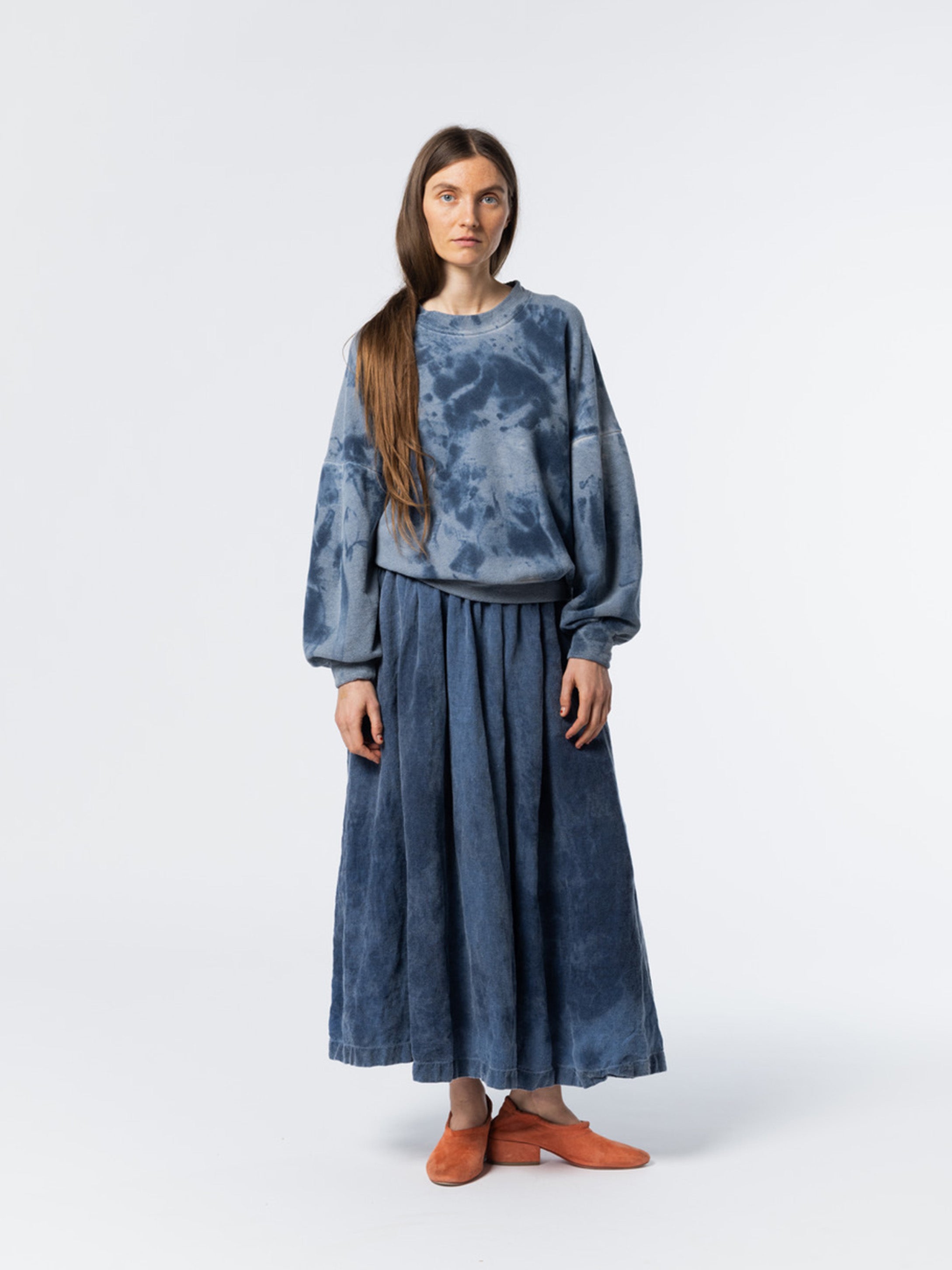 Woman wearing a blue tie-dye outfit from Anntian on a white background