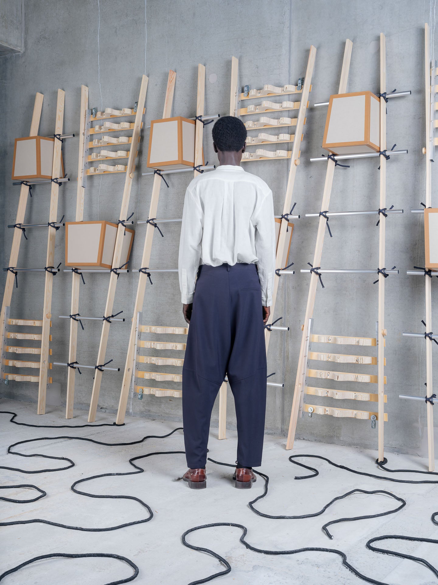 Back view of Henrik Vibskov Ants Pants in Dark Navy worn with a white shirt.