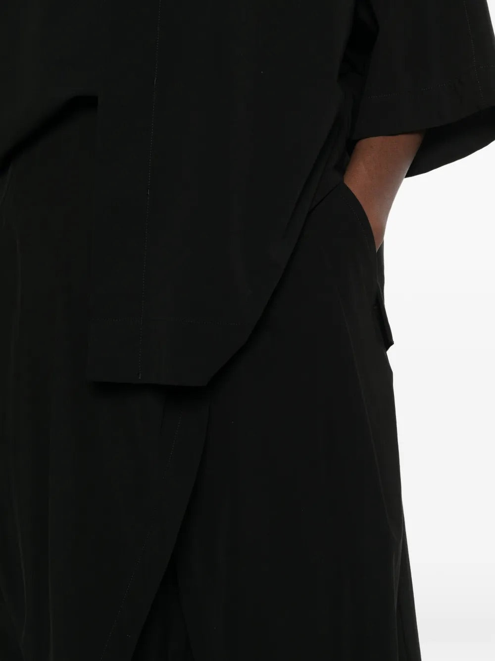 Issey Miyake April SS26 Looped Pants in Black detail of wrap-inspired construction and side pocket