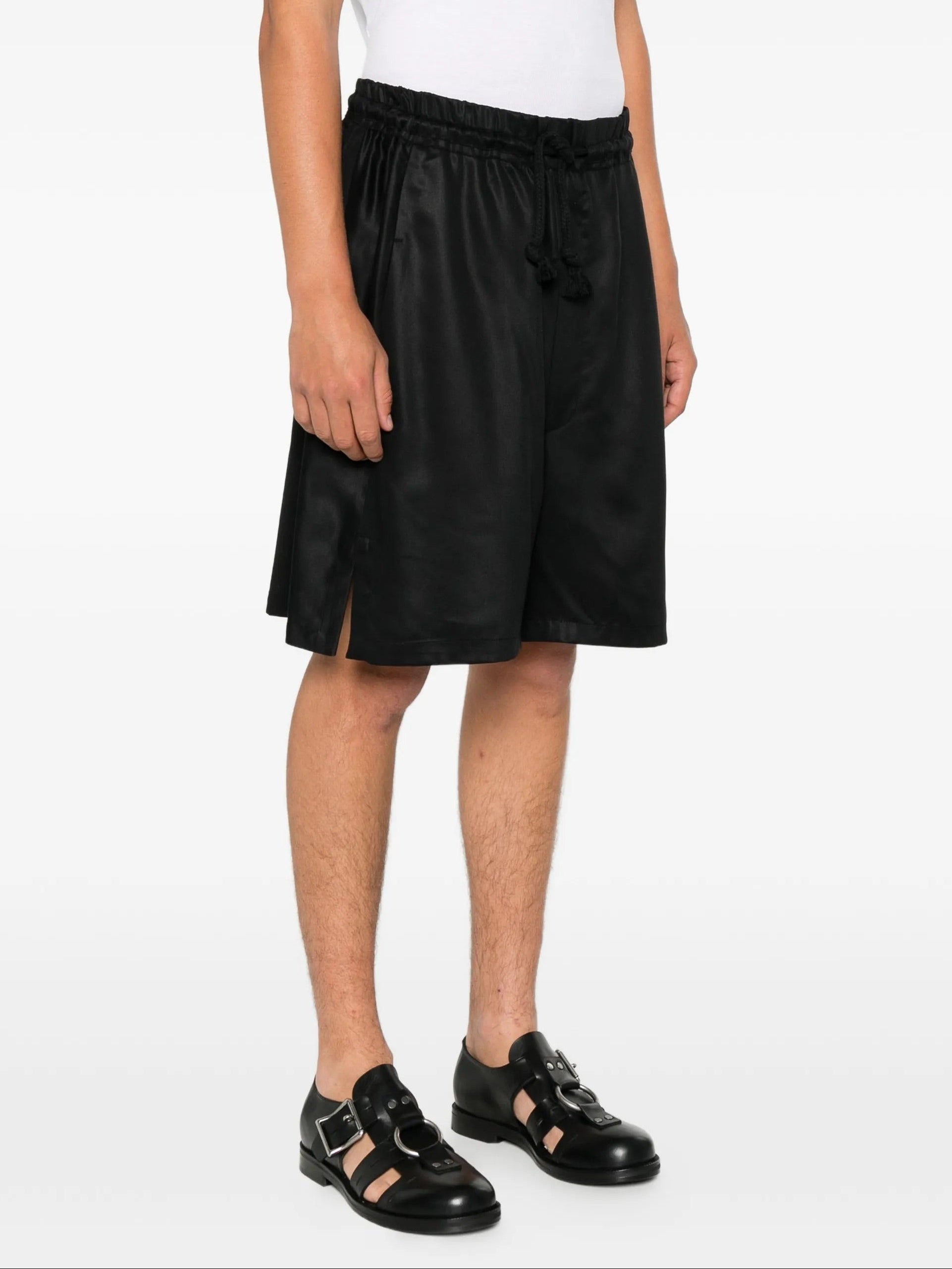 House Of The Very Islands Asher Pants in Black - side view on model showing side slits and relaxed silhouette