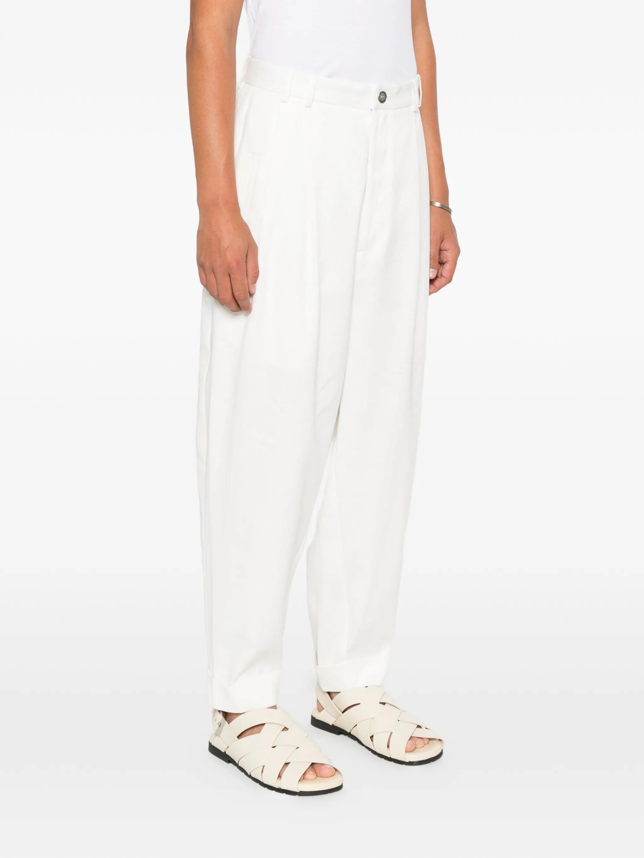 House Of The Very Islands Blake Trousers in Off White - front view on model showing button and zip fly closure and belt loops
