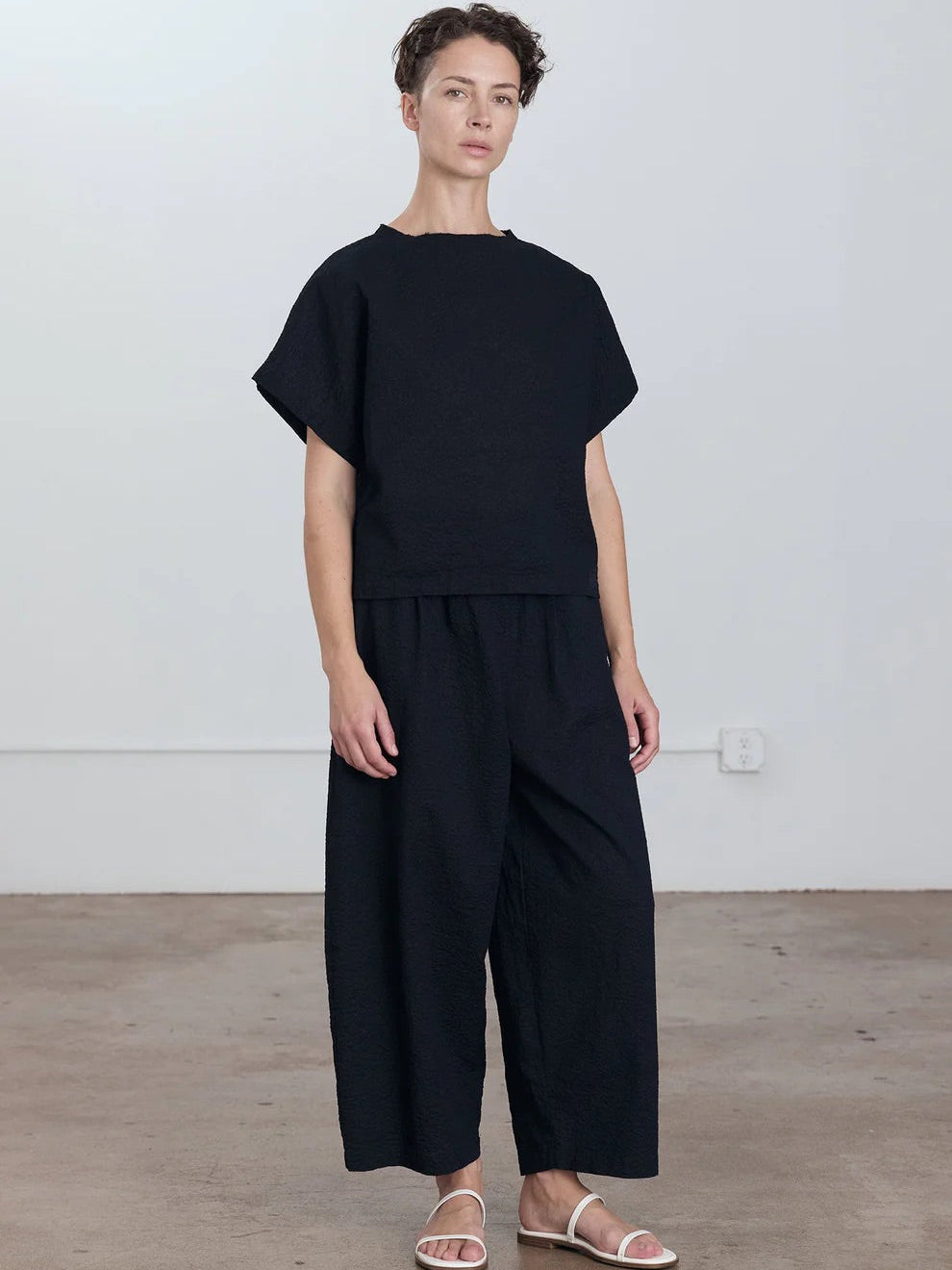 Black Crane Boxed Top in Midnight - full length front view on model showing regular fit and raw edge crew neck
