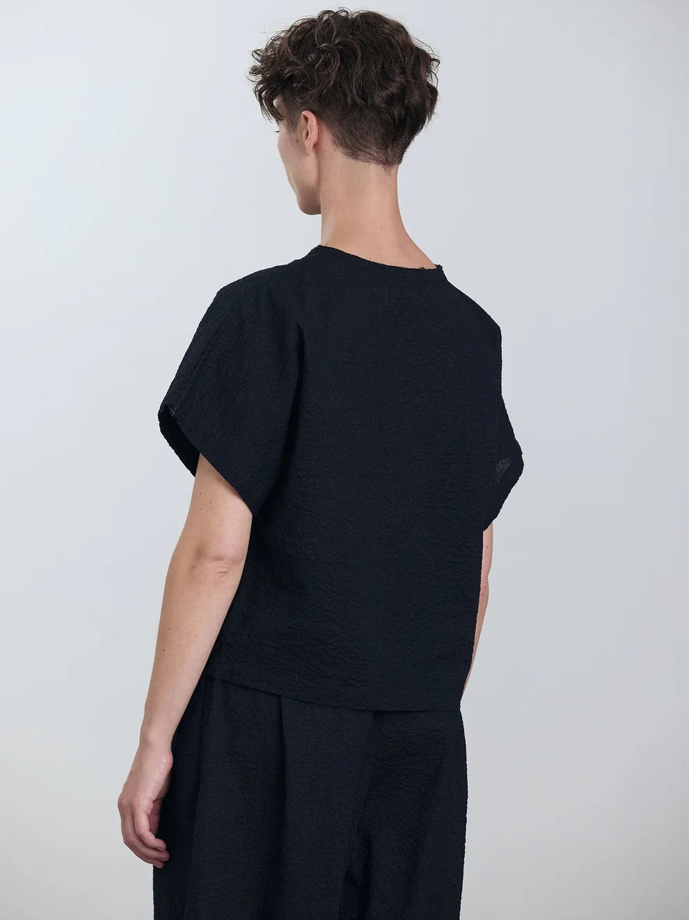 Black Crane Boxed Top in Midnight - three-quarter view on model showing boxed silhouette and regular fit