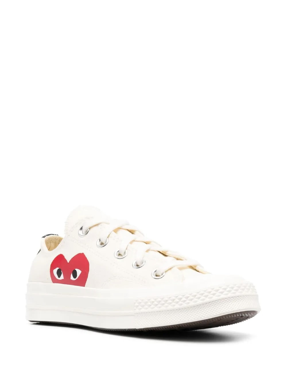 Comme des Garçons Play x Converse Chuck 70 low-top sneakers in white, three-quarter front view, red CDG heart logo and silver metal eyelets