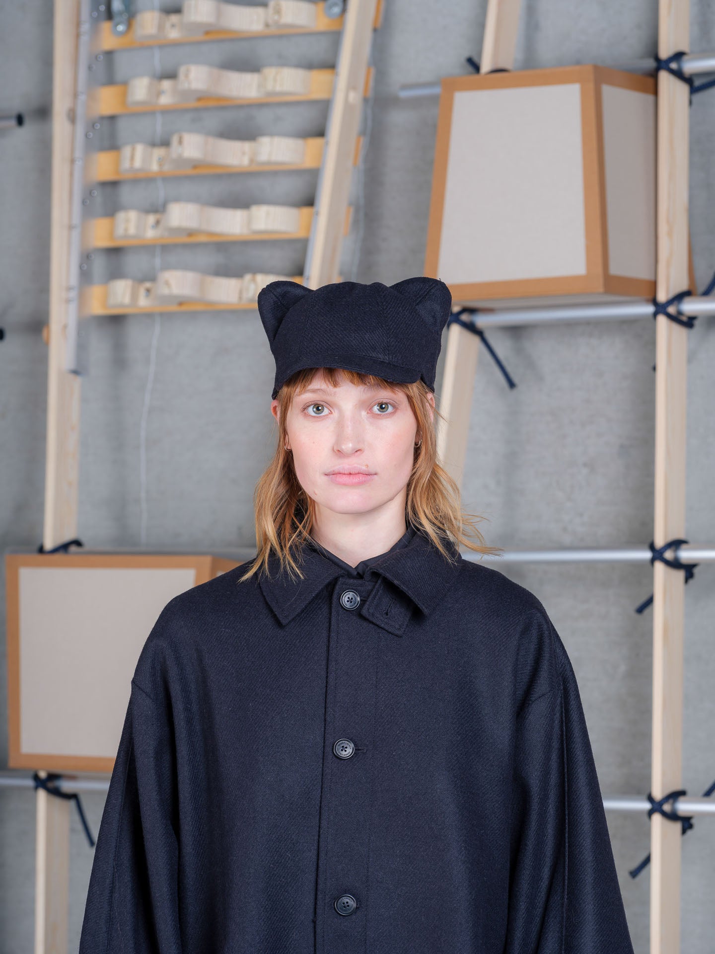 Model wearing Cara Eyed Cap in Black by Henrik Vibskov front portrait