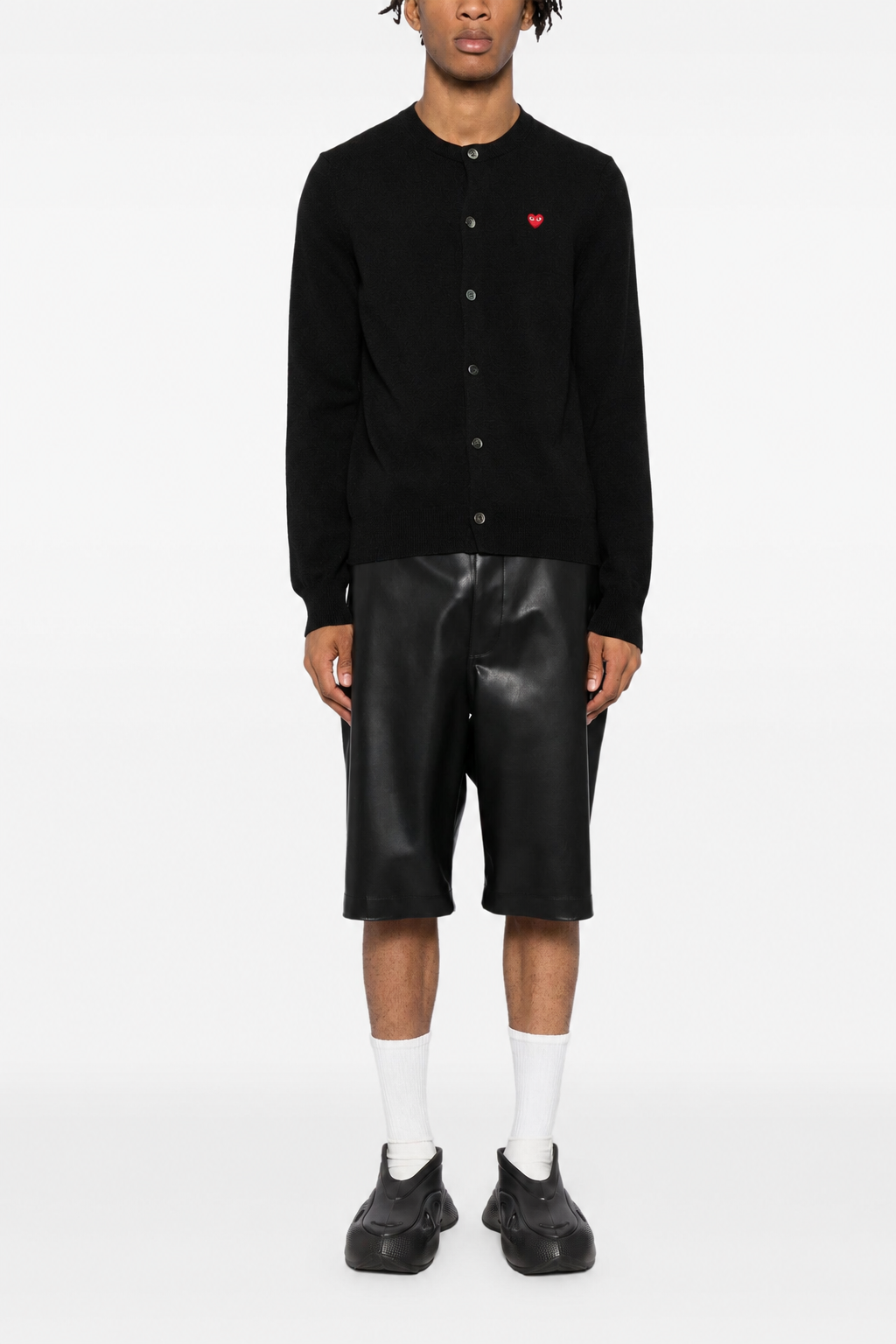 Male model wearing Comme des Garçons Play black cardigan with red heart logo, button front and ribbed trims