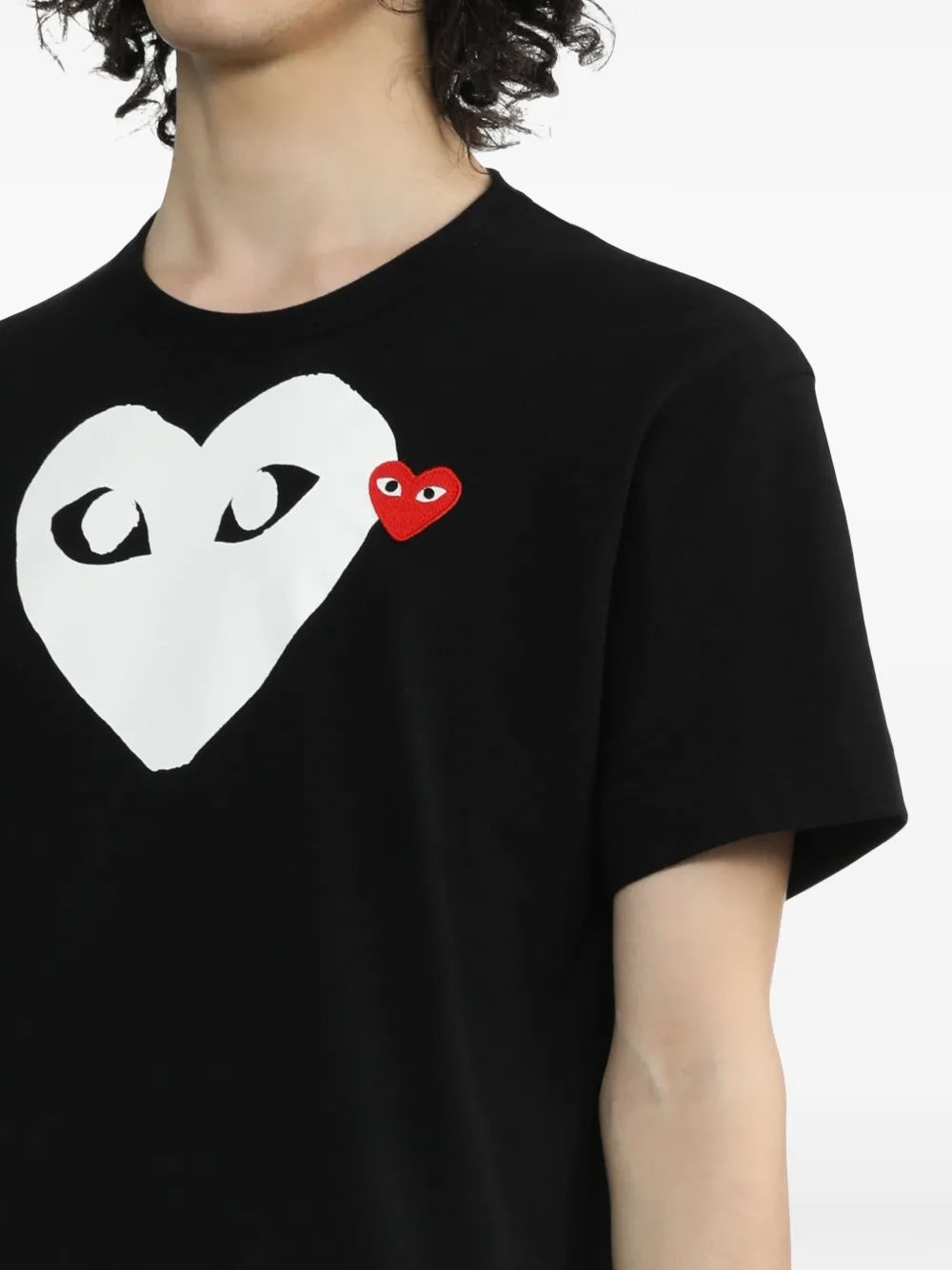 Close-up of Comme des Garçons Play Unisex Short Sleeve Big Heart T-Shirt in black showing white heart graphic and red embroidered heart logo