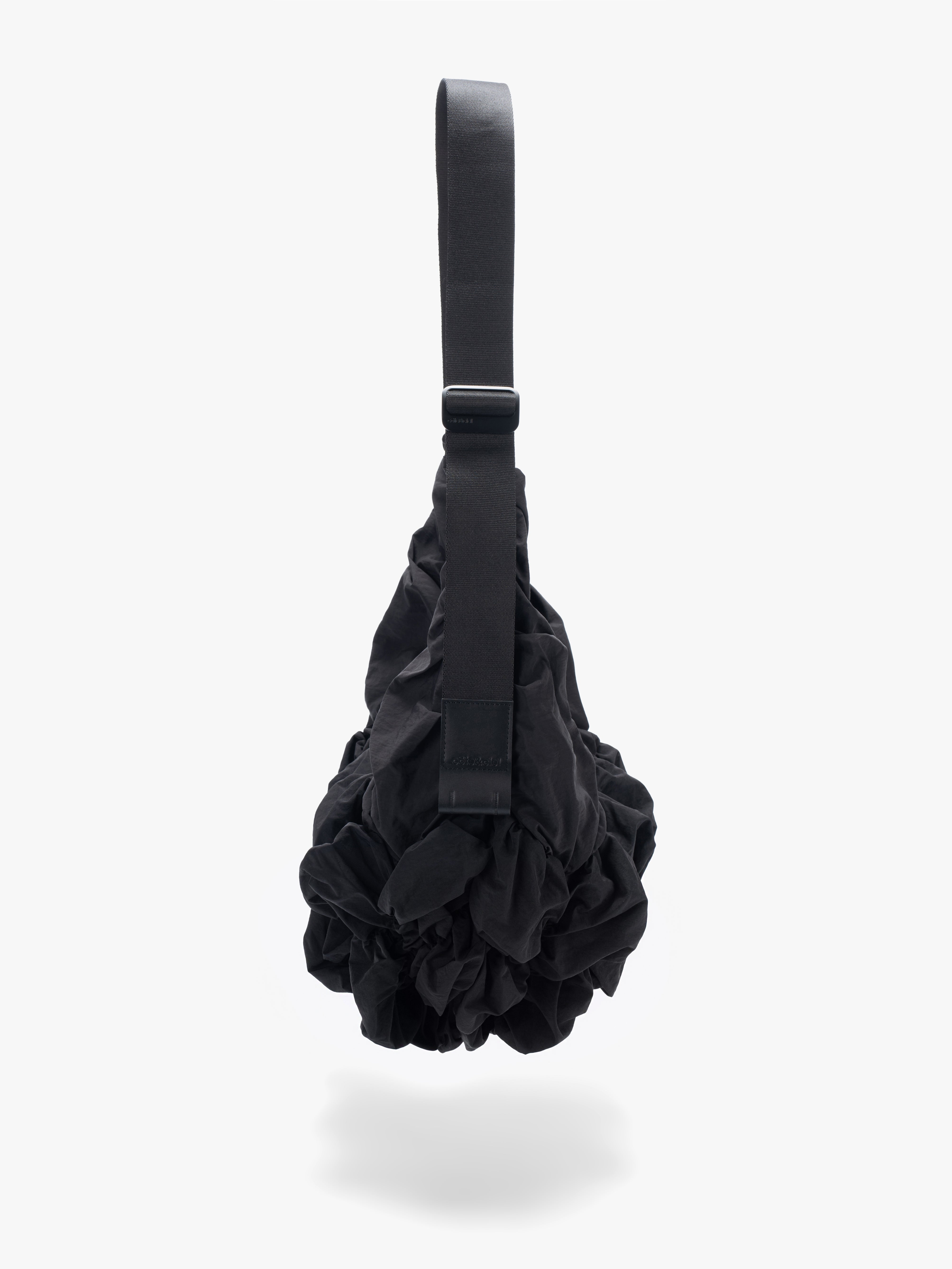 Côte&Ciel Hyco S Otra Gathered crossbody bag in black, side view showing structured profile and external front pocket for quick access.