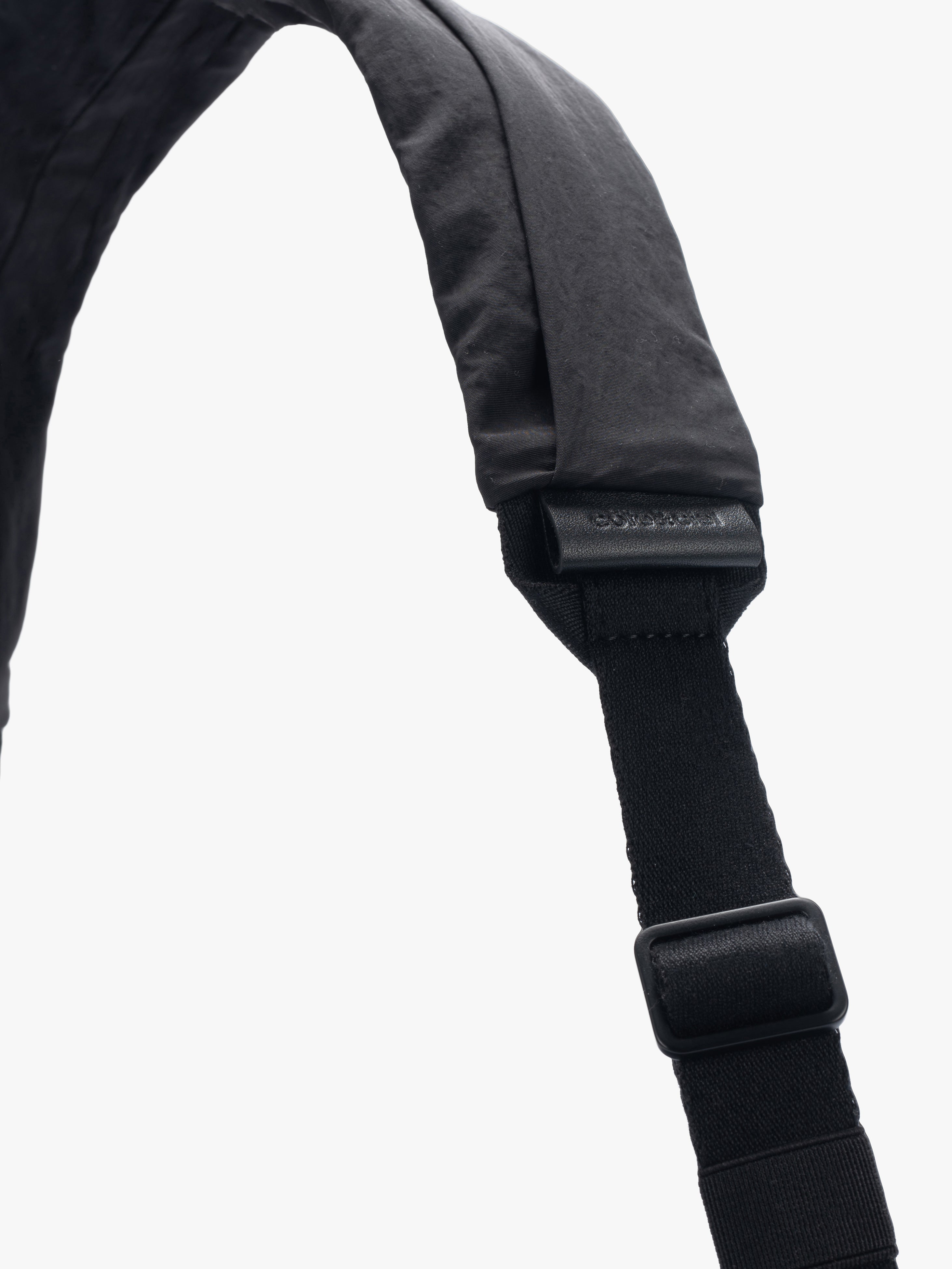 Closeup of Côte&Ciel Orne Otra Gathered black bag, focusing on detachable ADDA shoulder strap and ergonomic design.