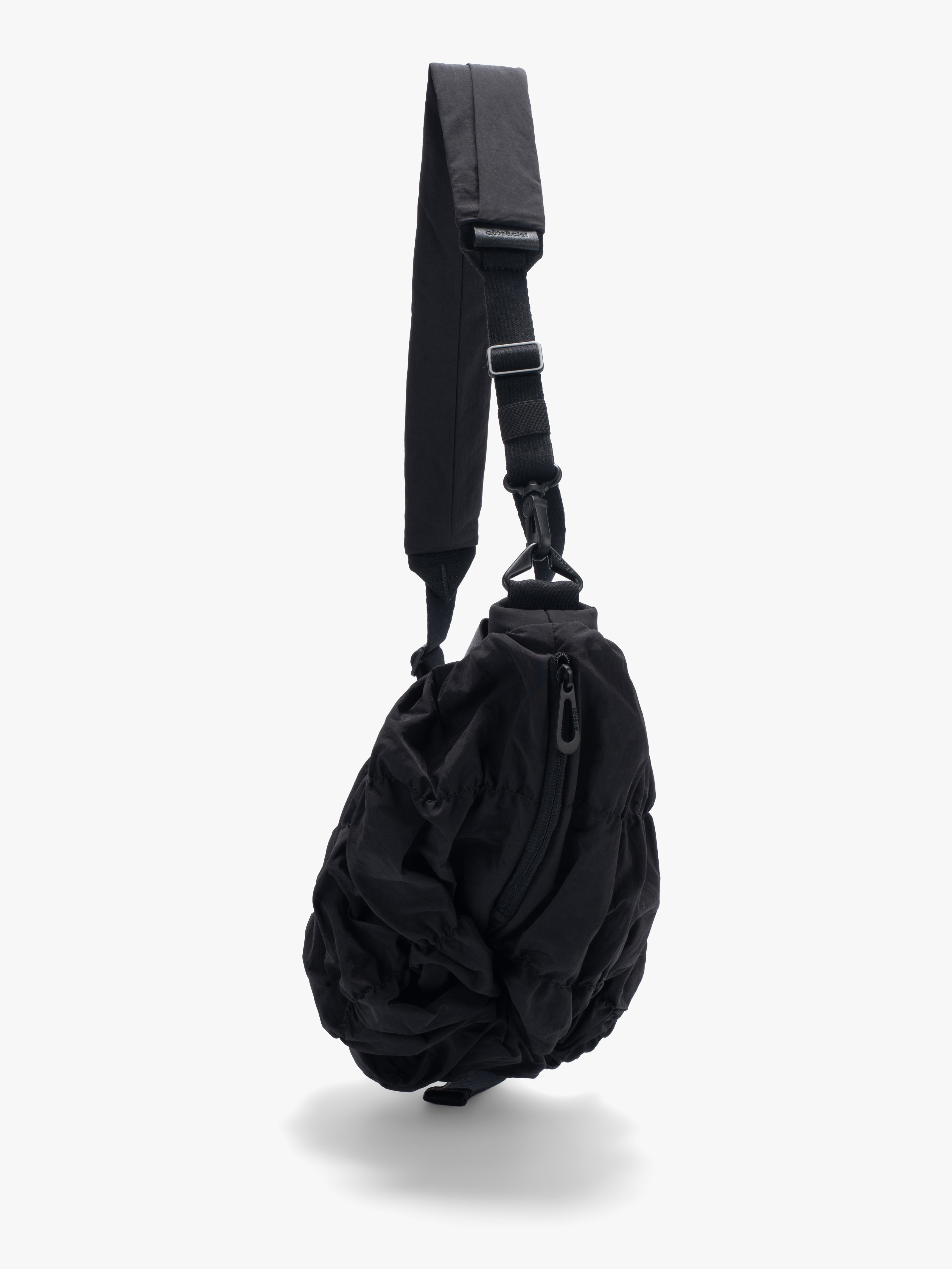 Côte&Ciel Orne Otra Gathered crossbody bag in black, diagonal view highlighting sculptural gathered nylon and subtle twisted base detail.
