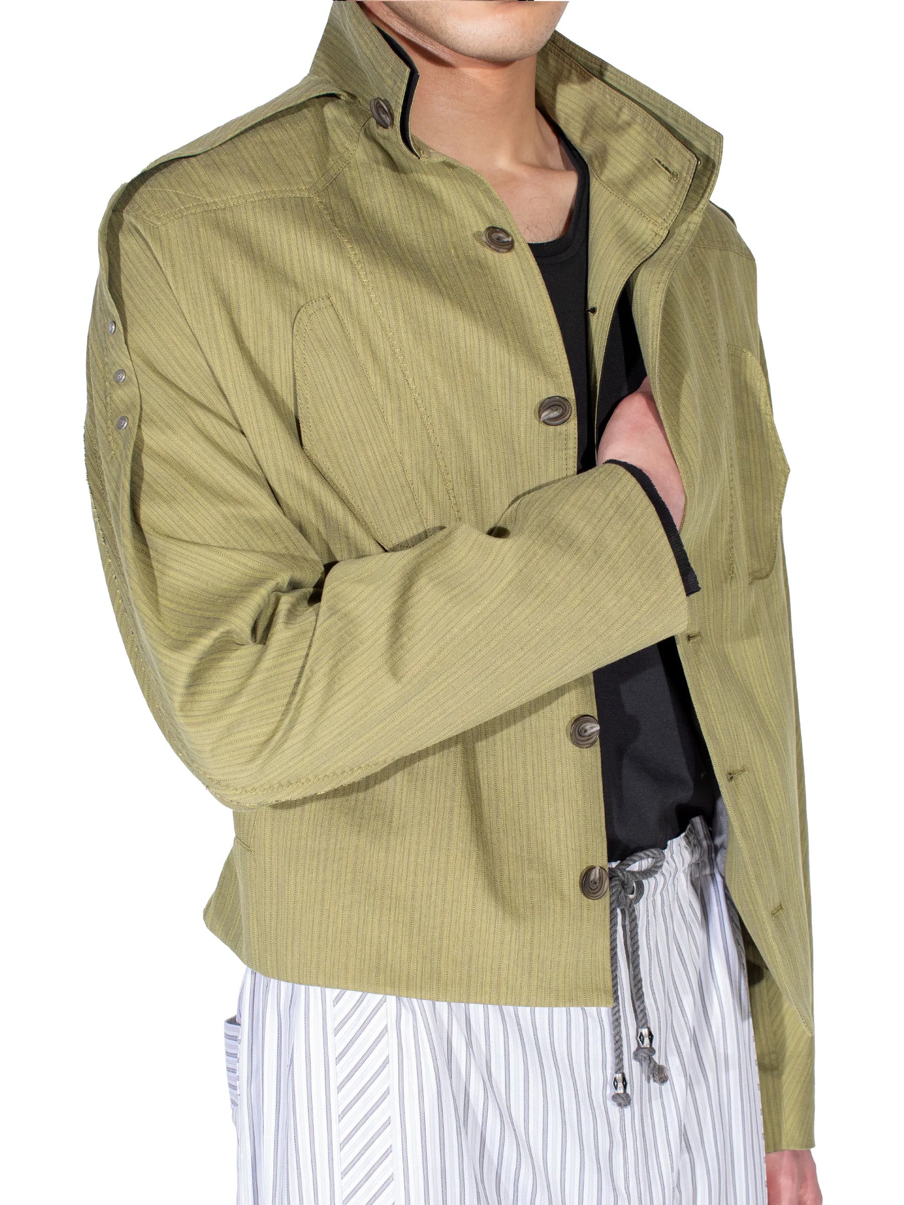 Detail view of the Kiko Kostadinov Egreta Jacket in Lime Stripe showing the layered construction.