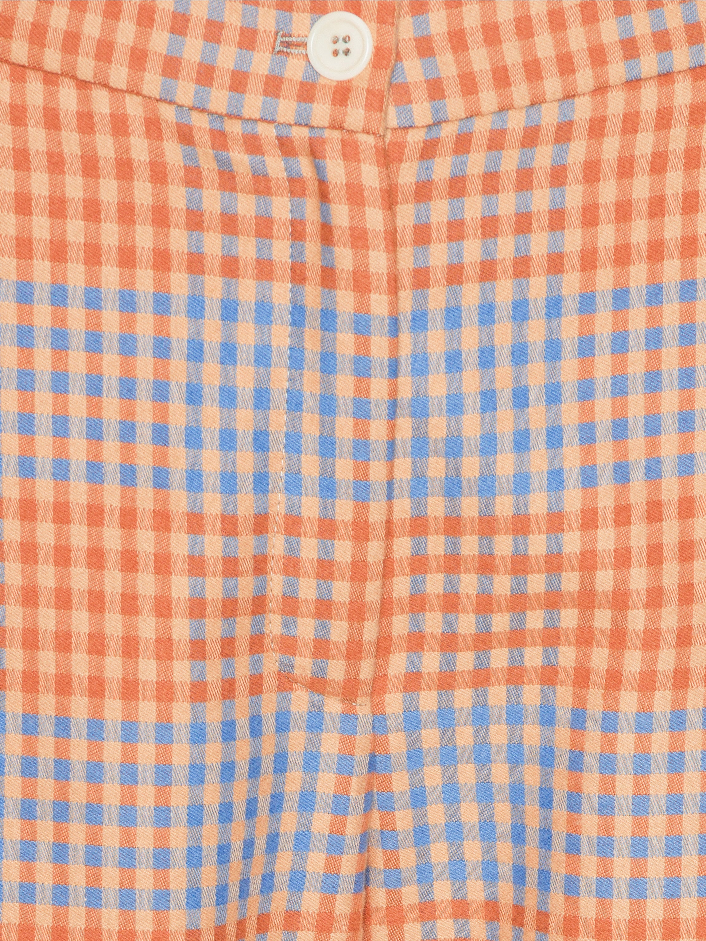 Close-up of a checkered fabric with orange and blue pattern
