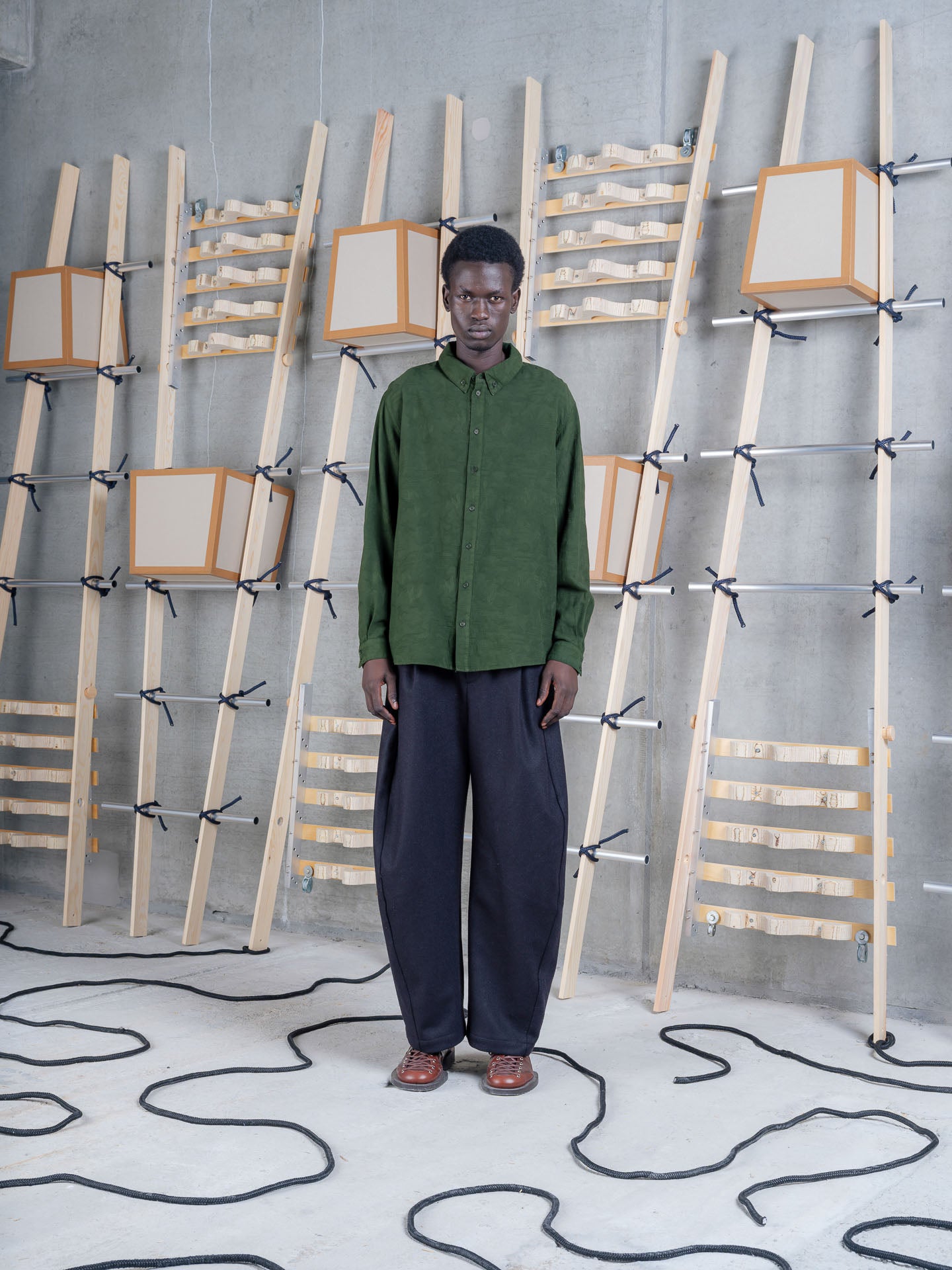 Henrik Vibskov Block Shirt Bottle Green, model front view, shirt styled with navy wide-leg trousers