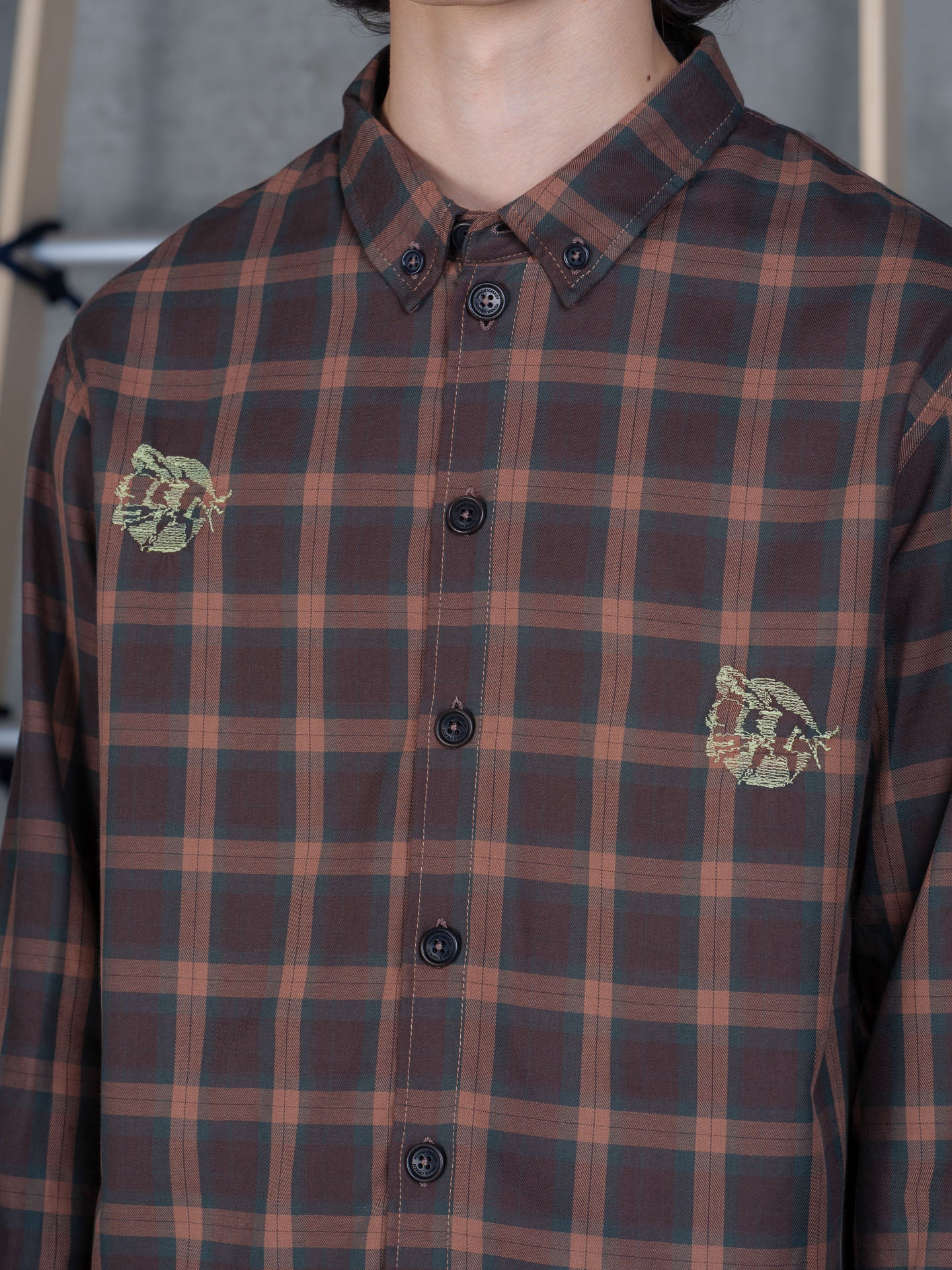 Henrik Vibskov Block Shirt Brown Cotton Checks, close-up detail of embroidered motif and button placket