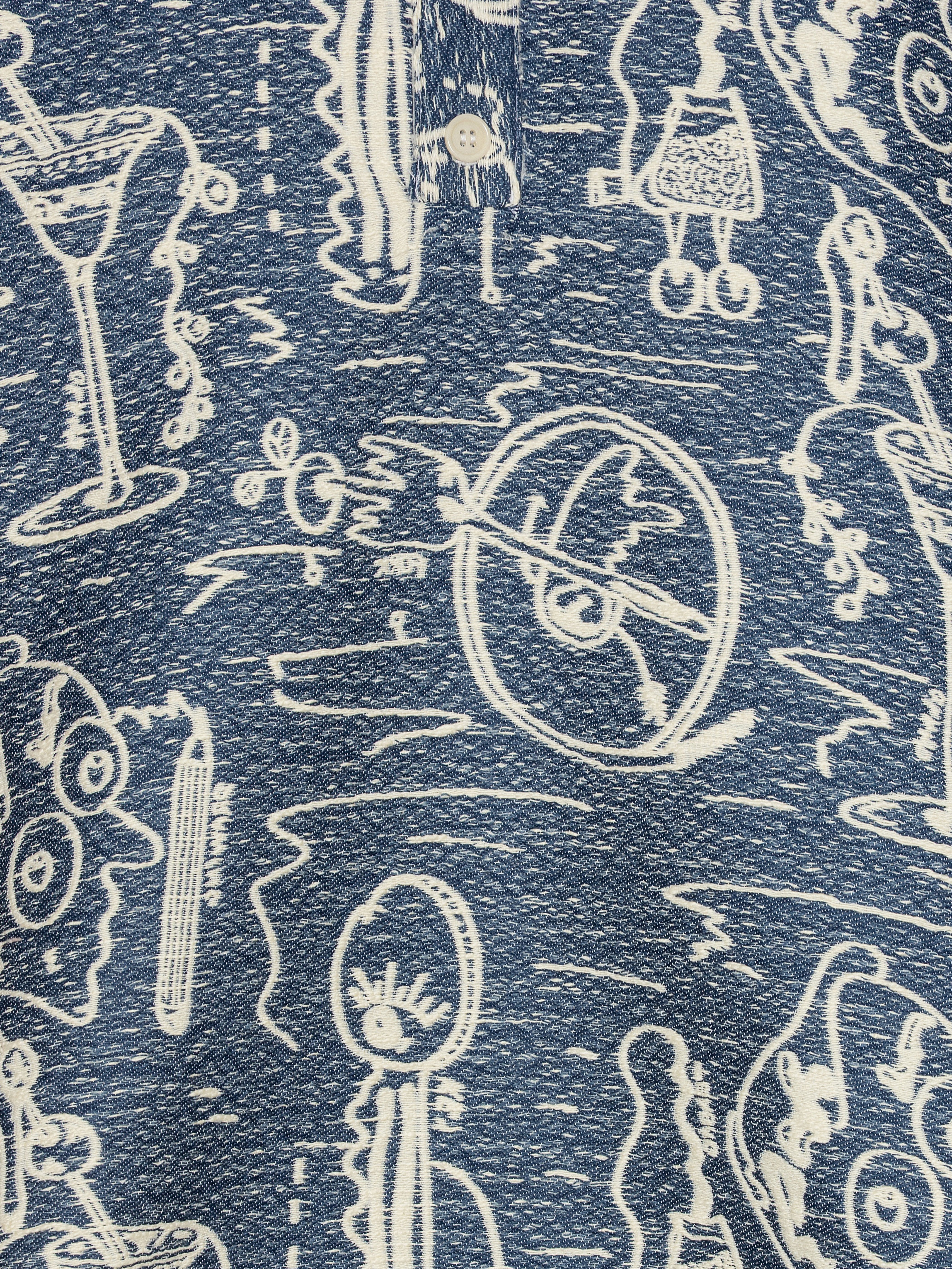 Close-up of the Dart Polo Shirt showing the grey-blue fabric texture, white doodle artwork, and mandarin collar with button detailing.