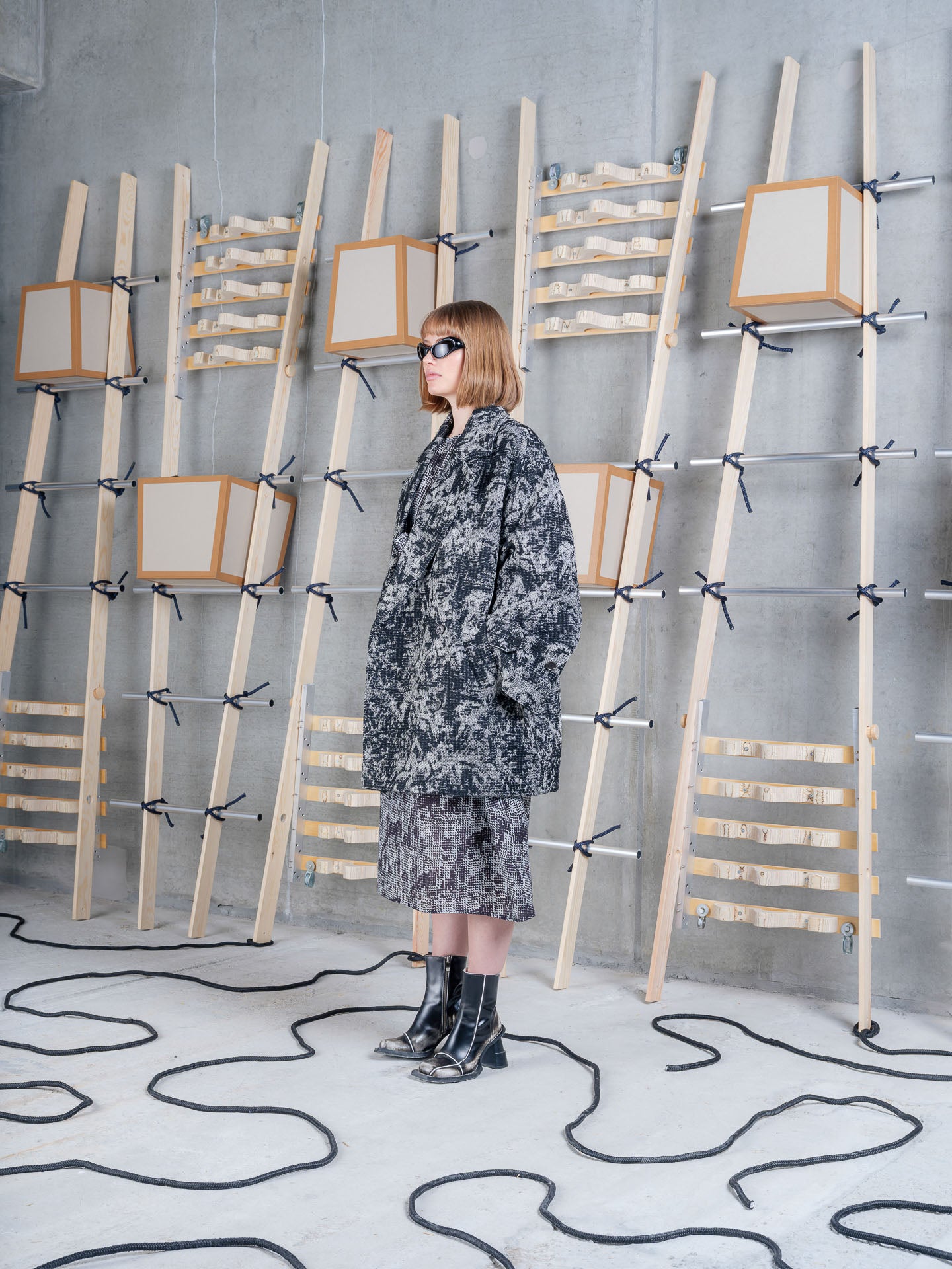 Henrik Vibskov Dimout Coat in Black 3D White on-model side profile view, raised black and white pattern, oversized fit, patch pockets