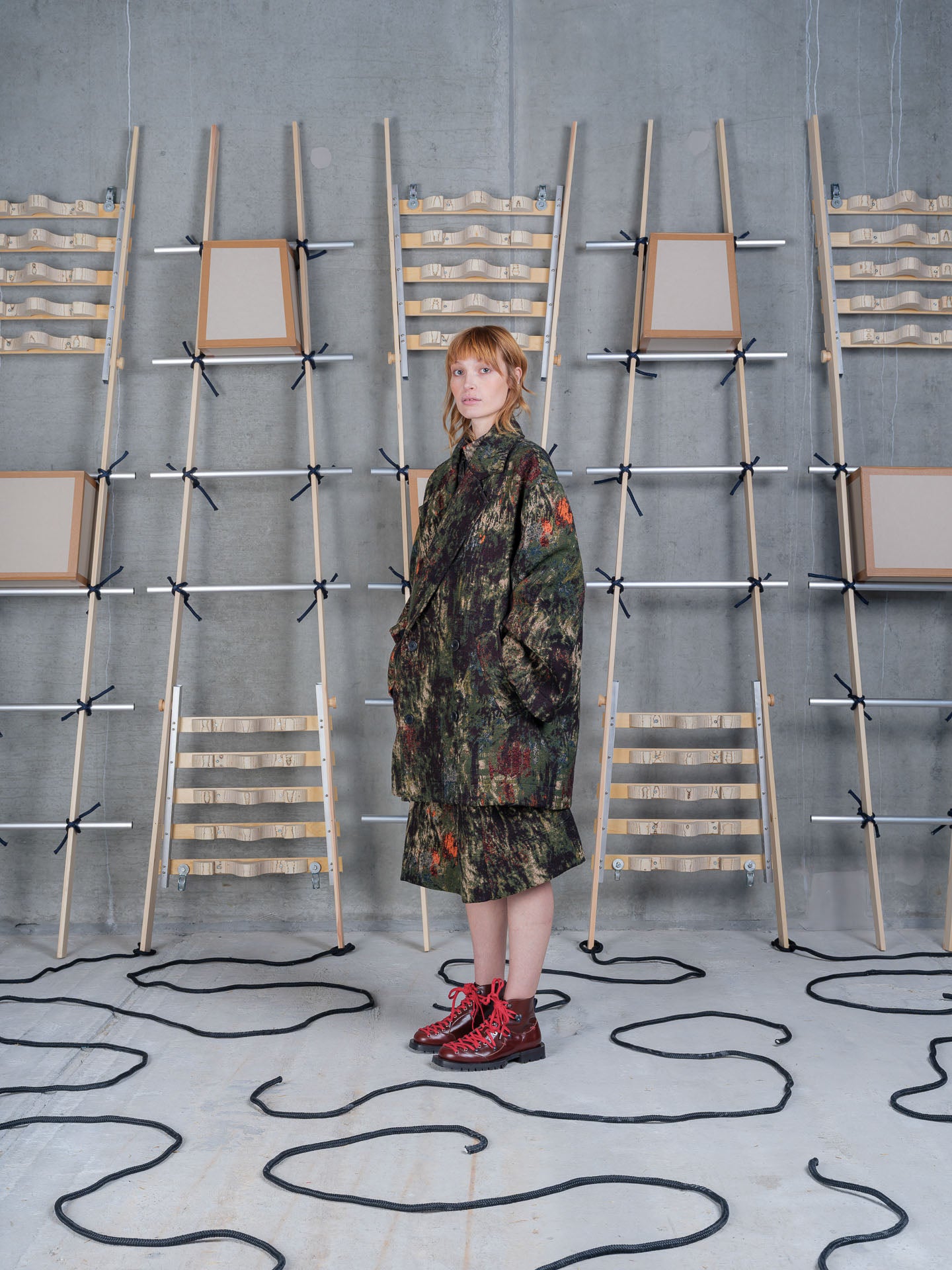 Henrik Vibskov Dimout Coat in Gobelin Swamp worn on model, full-length front view, jacquard tapestry print, notched lapel, double-breasted fastening