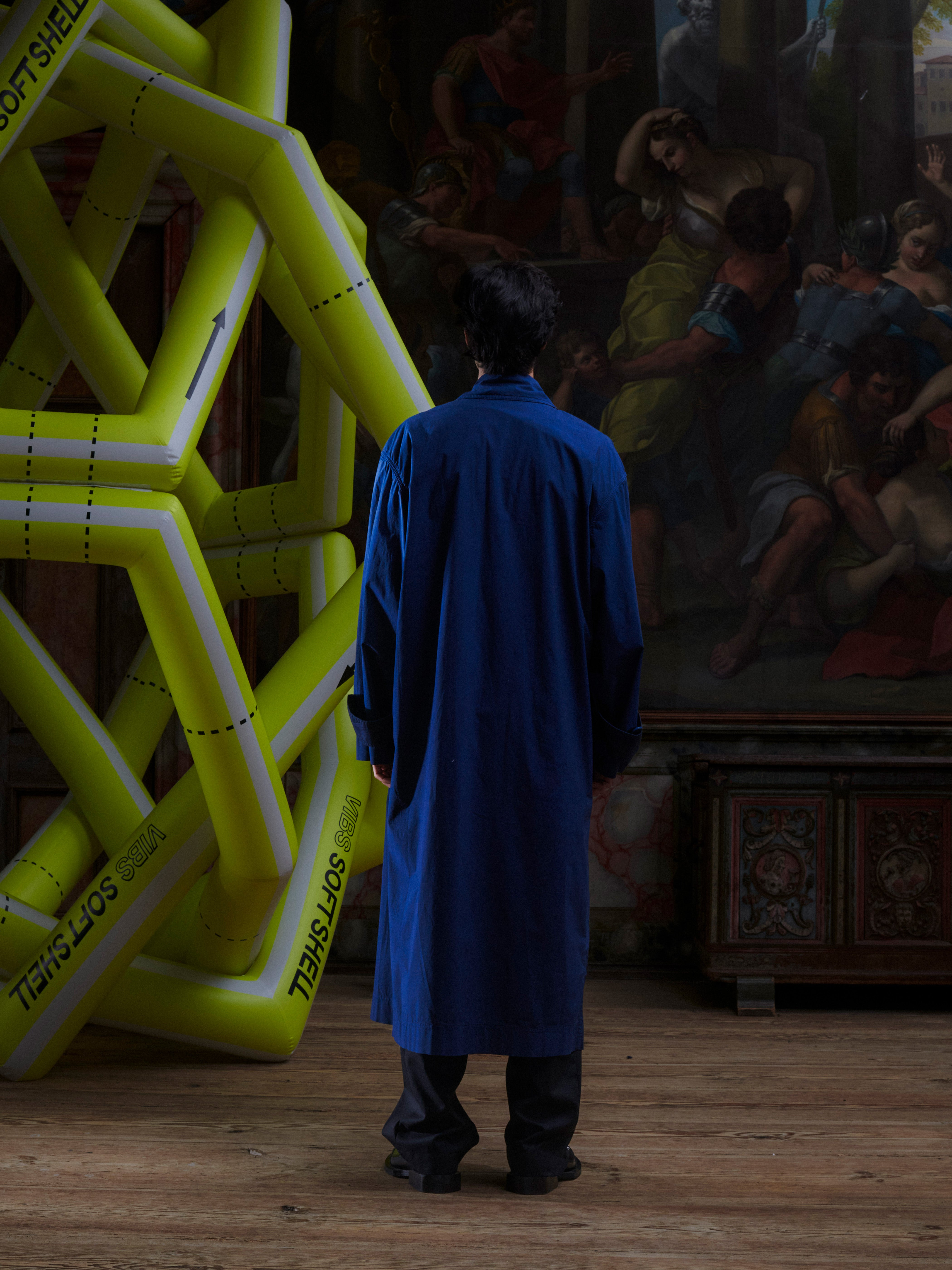 Back view of model wearing the Dimout Long Coat in Navy, highlighting the smooth tailored back and long-line cut.