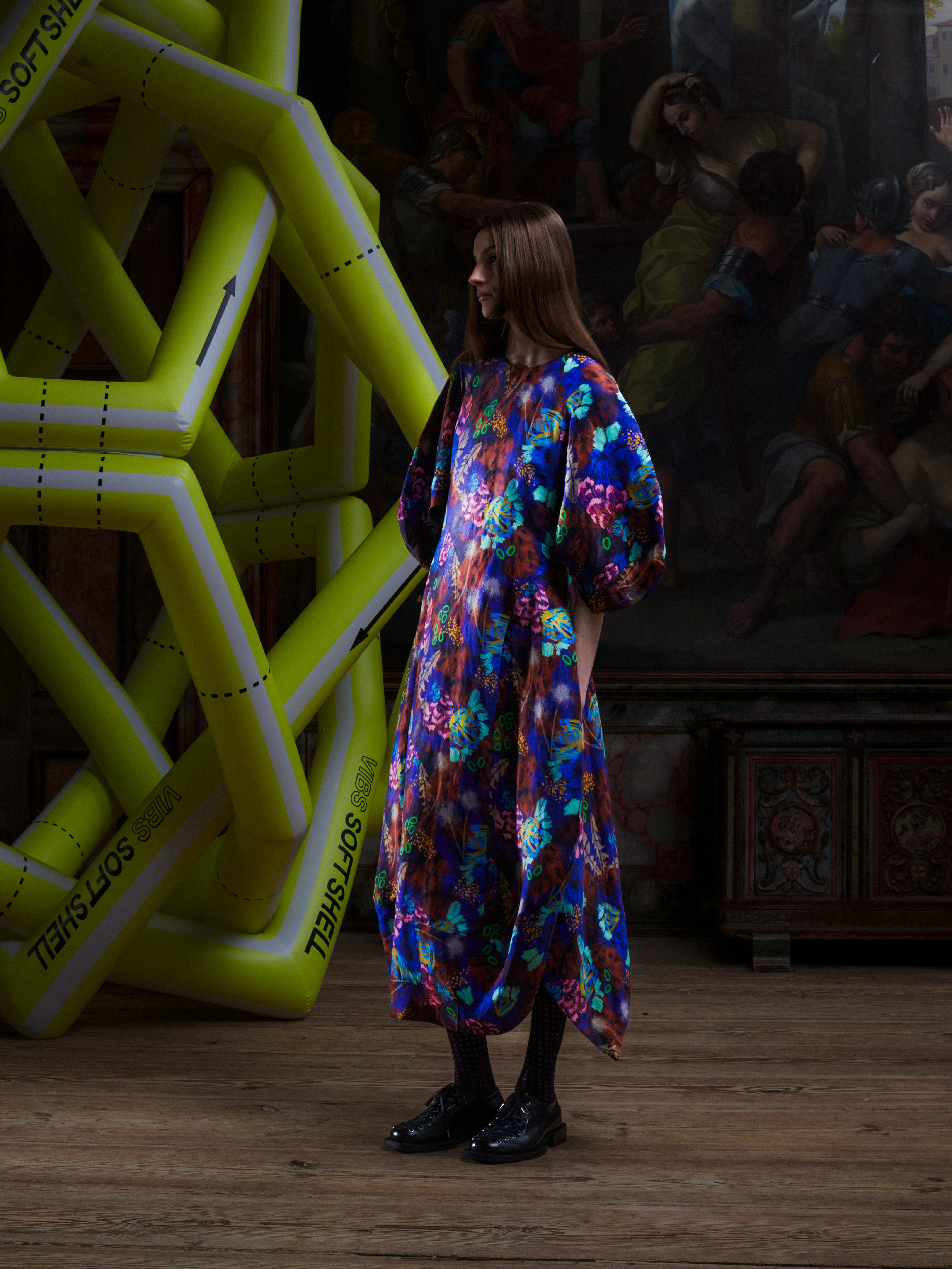 Side view of model wearing the Double Bass Dress in Space Chickens, showing the curved hourglass shape and drape of the printed fabric.