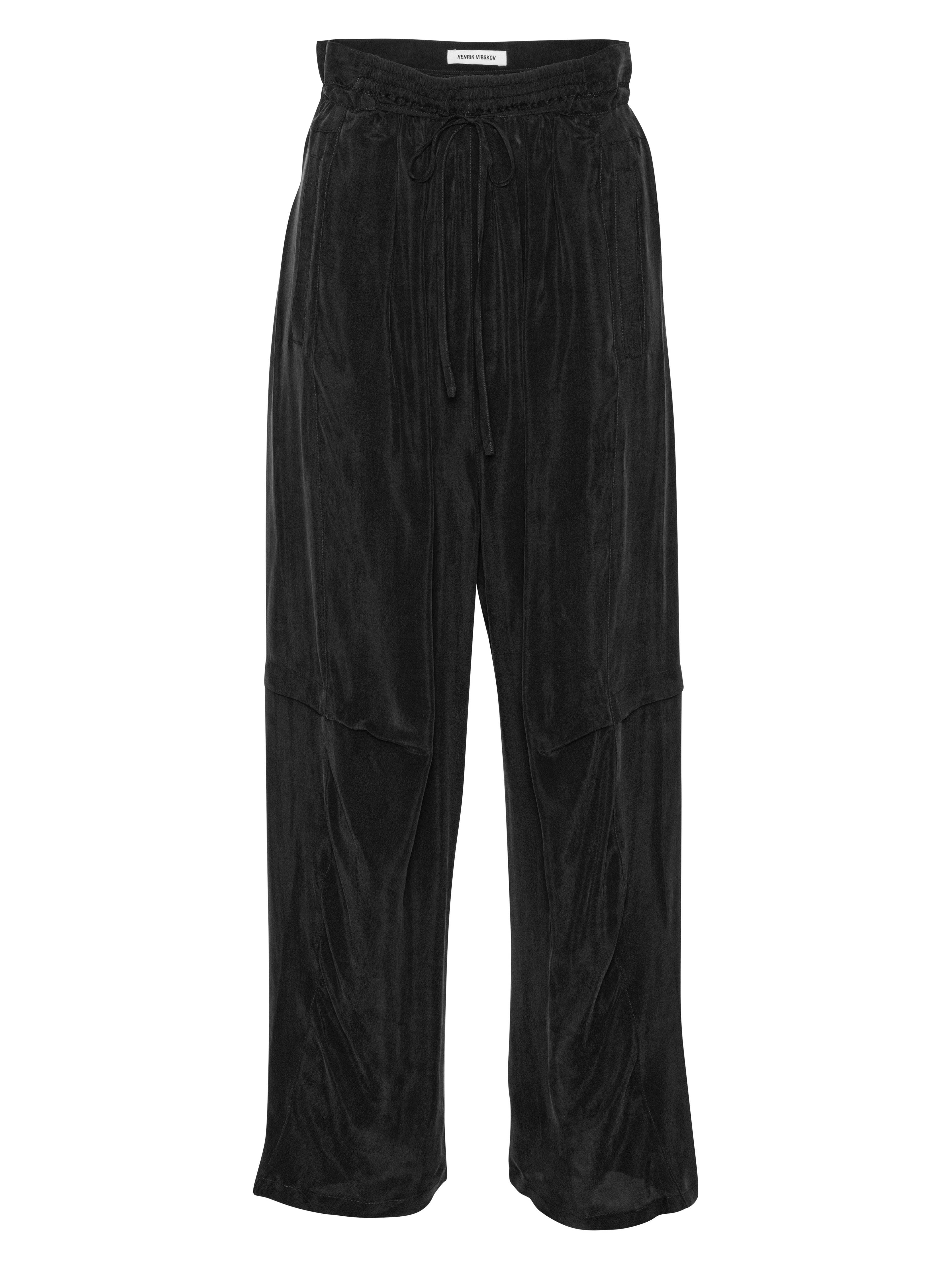 Front view of the Drawstring Pants in Black, showing the straight-leg cut, elastic drawstring waistband, and side pockets.