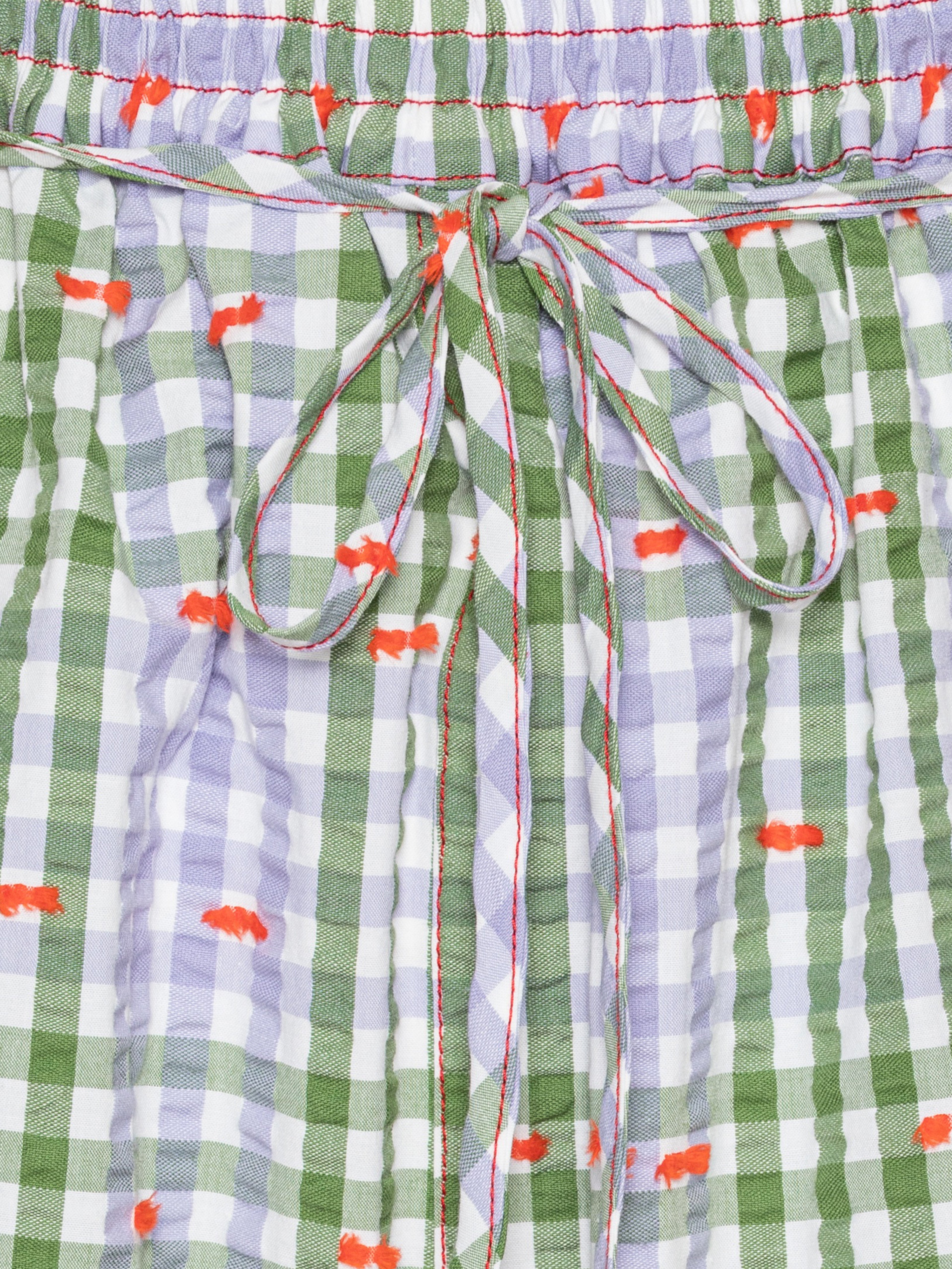 Close-up of the Drawstring Shorts in Checks Fillé, highlighting the purple and green checks, orange contrast stitching, and elastic waistband with drawstring.