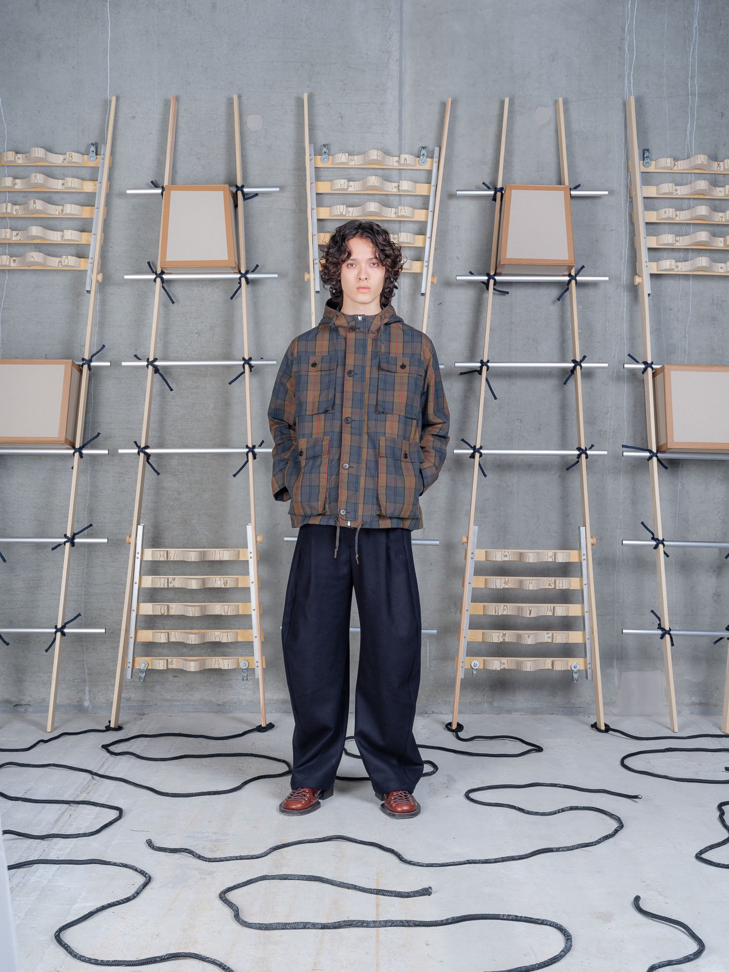 Henrik Vibskov Field Parka in Tartan on-model three-quarter view, shaped silhouette, four-pocket utility front, dry wax finish
