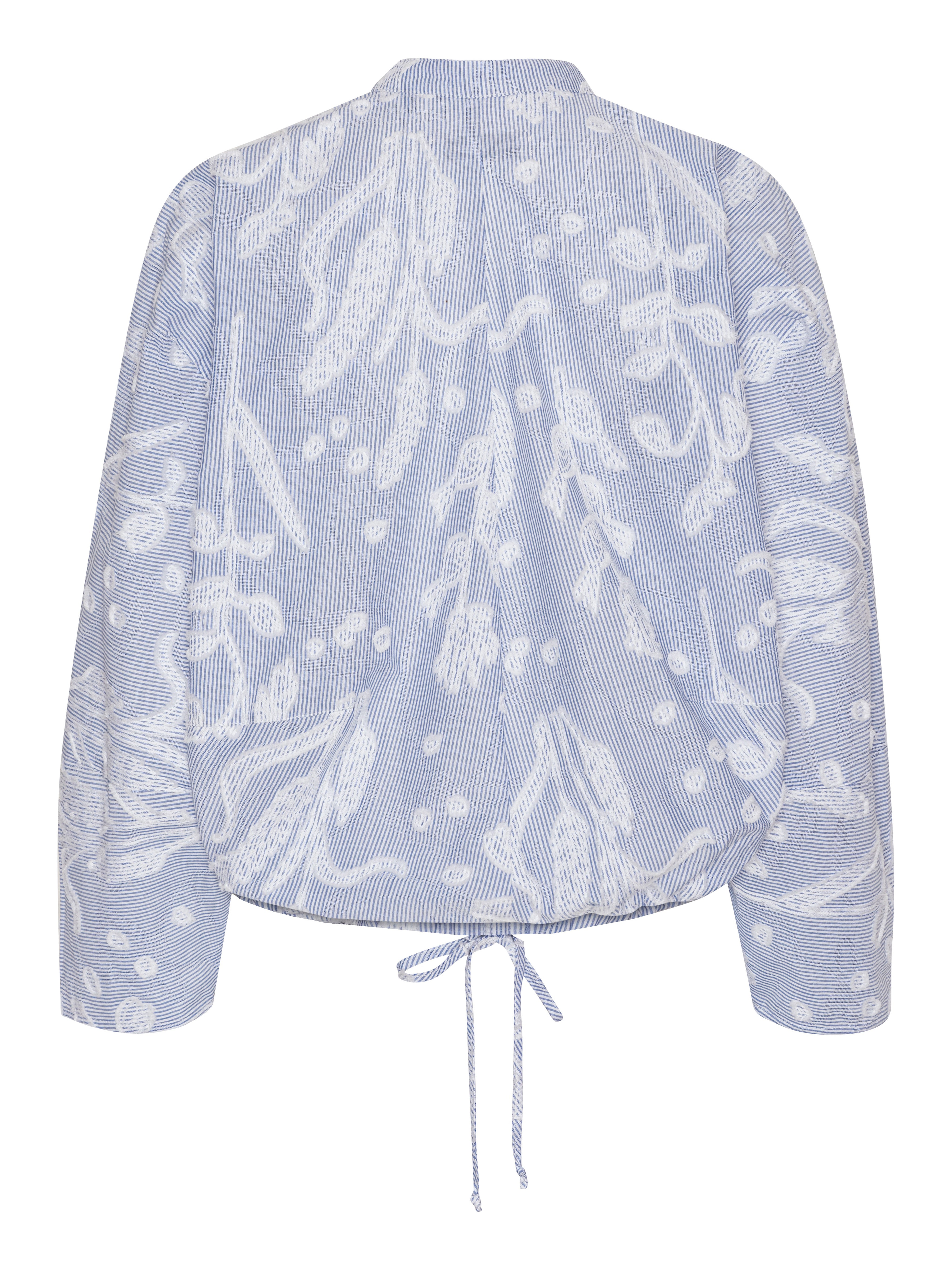 Back view of the Flat Shirt in light blue, highlighting the relaxed fit and elasticated hem.