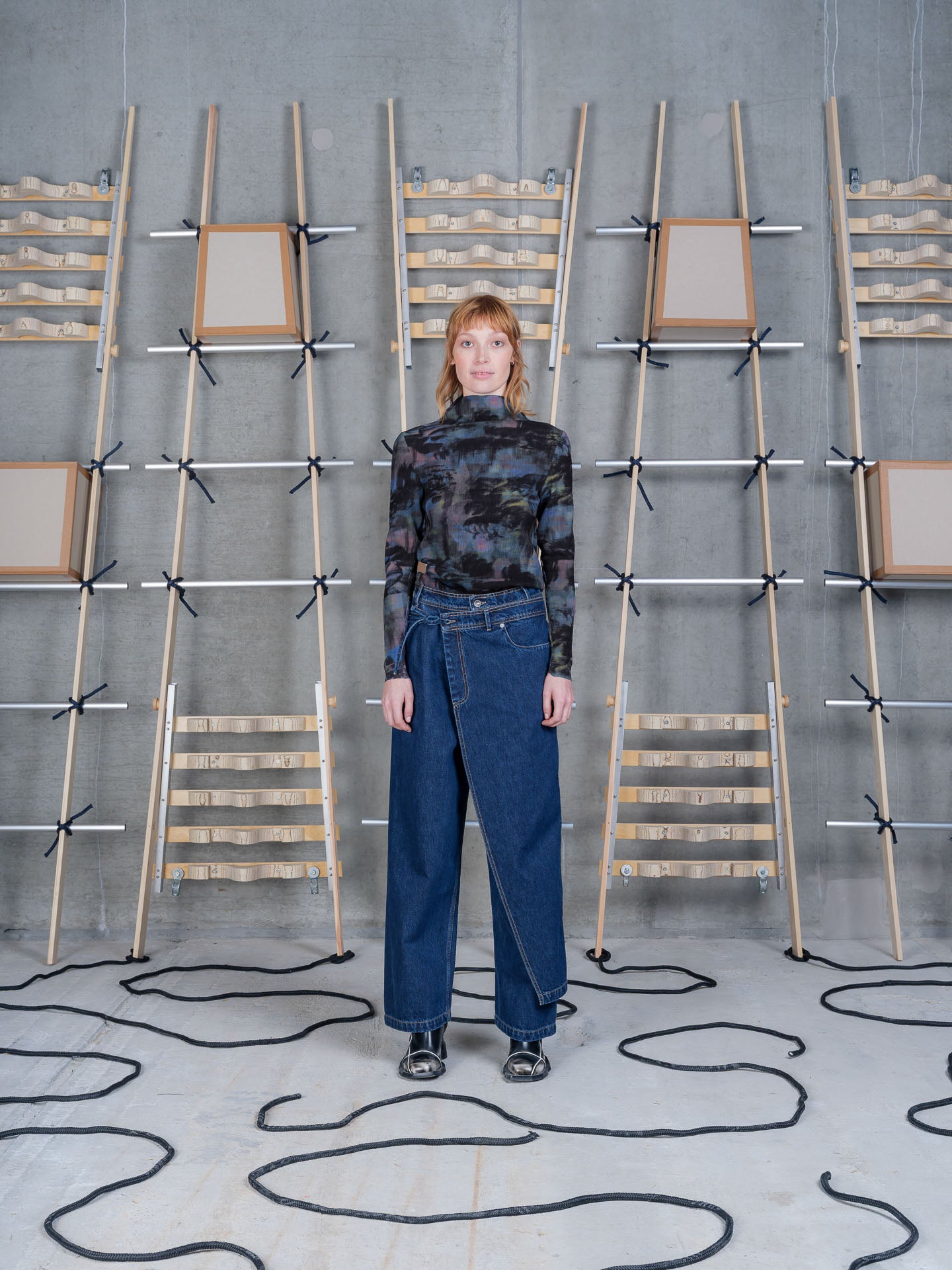 Henrik Vibskov Fly Pants Rinse Denim, model front view, styled with a printed mesh top