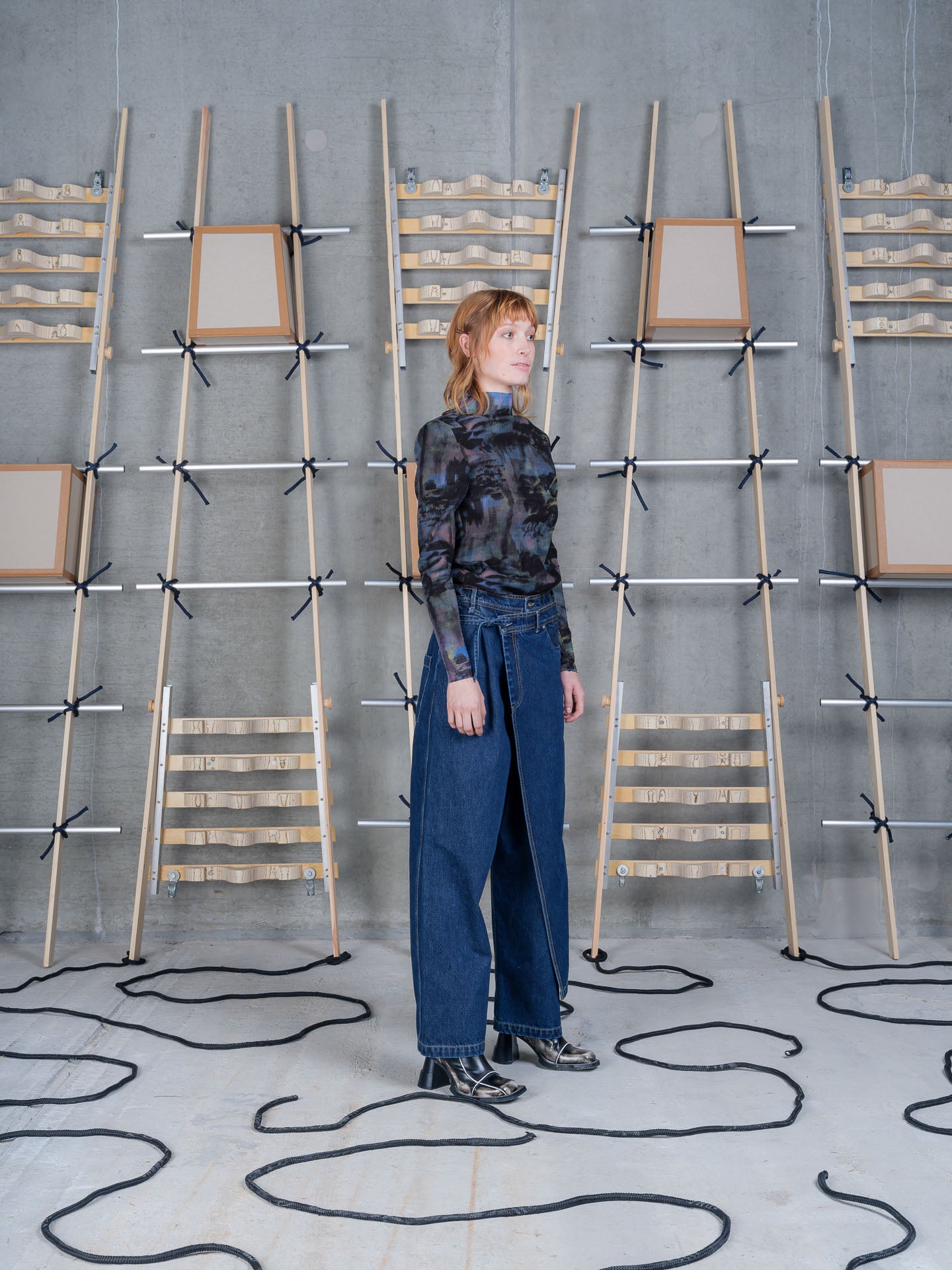 Henrik Vibskov Fly Pants Rinse Denim, model side view, showing asymmetric wrap front and wide leg