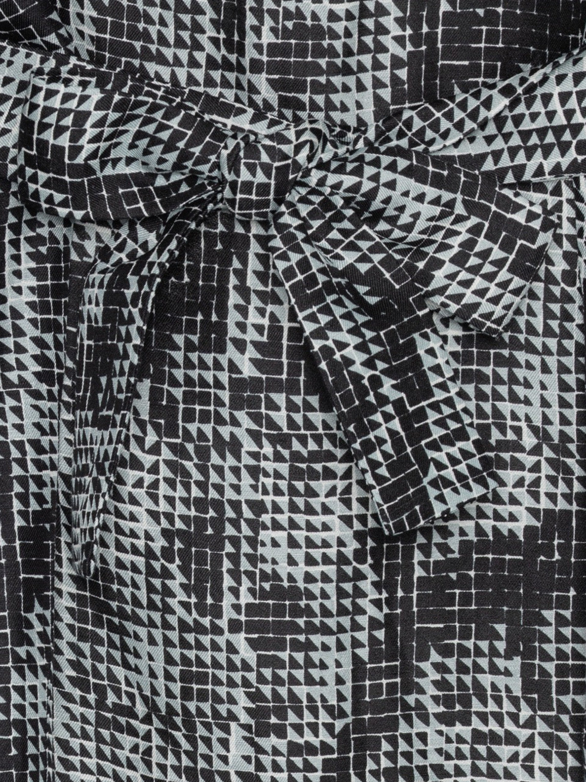 Close-up of the tie belt detail on the Henrik Vibskov Frown Silk Dress in Jumping Gents print