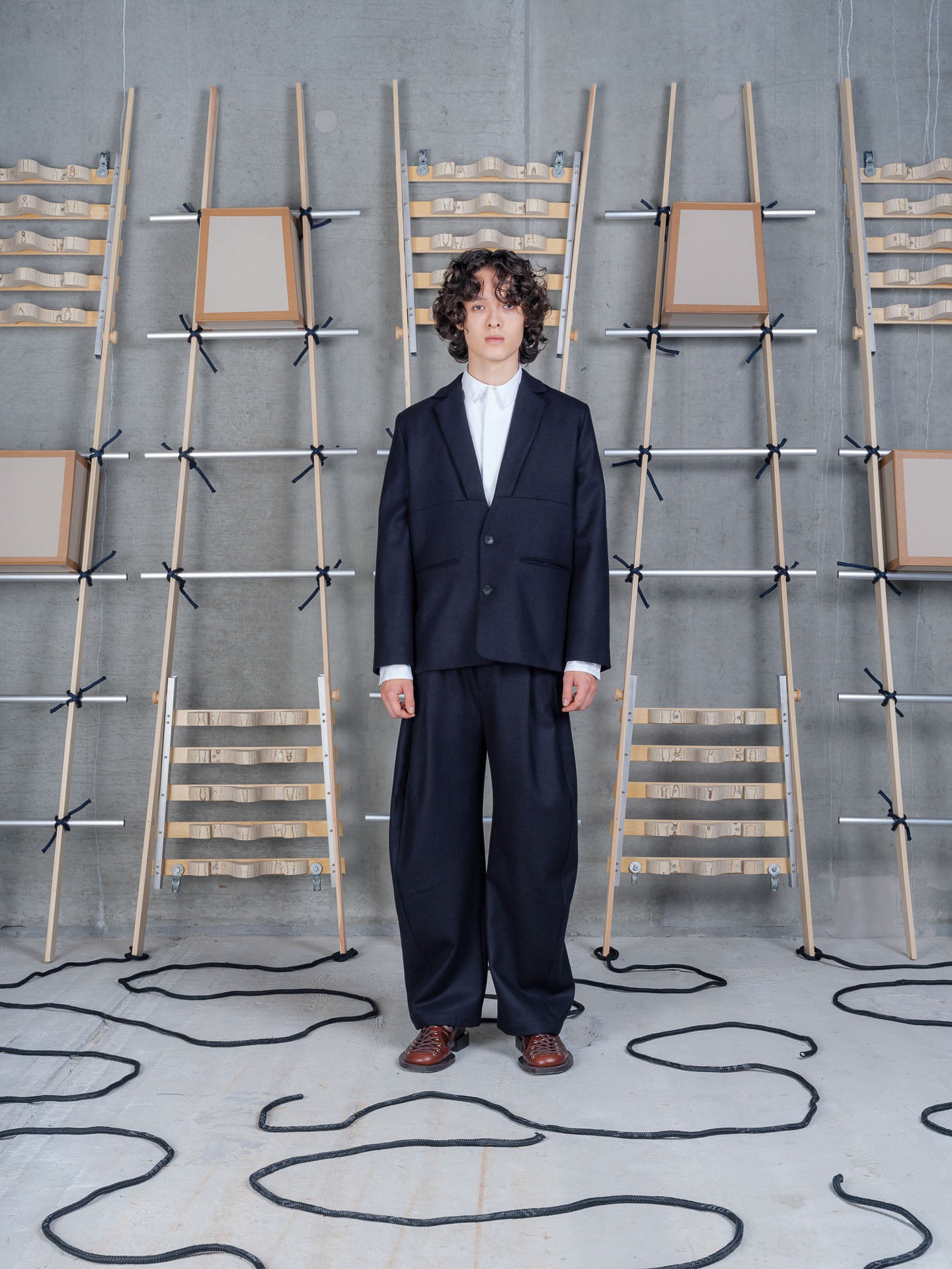 Henrik Vibskov Lonely Blazer in Black worn on model, full-length front view, relaxed tailoring, notched lapel, two-button fastening, dropped shoulder seam