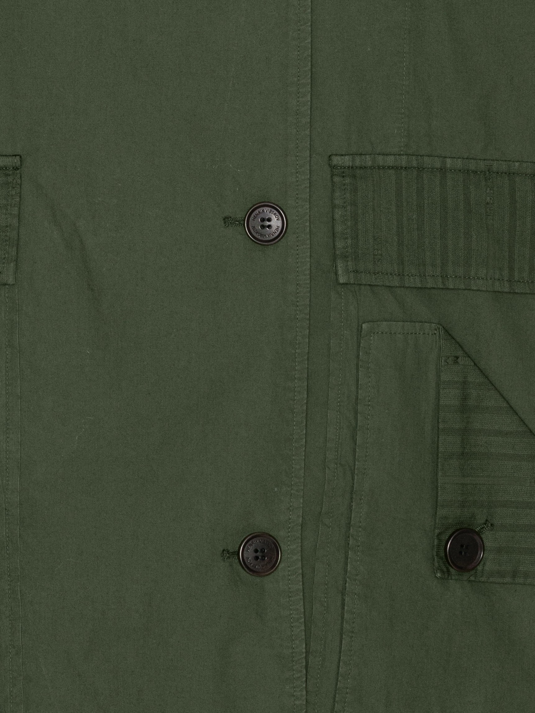 Close-up of checked details and classic collar on the Mid-Air Jacket in Garden Green navy green jacket – Henrik Vibskov Spring/Summer 2026 Key Collection