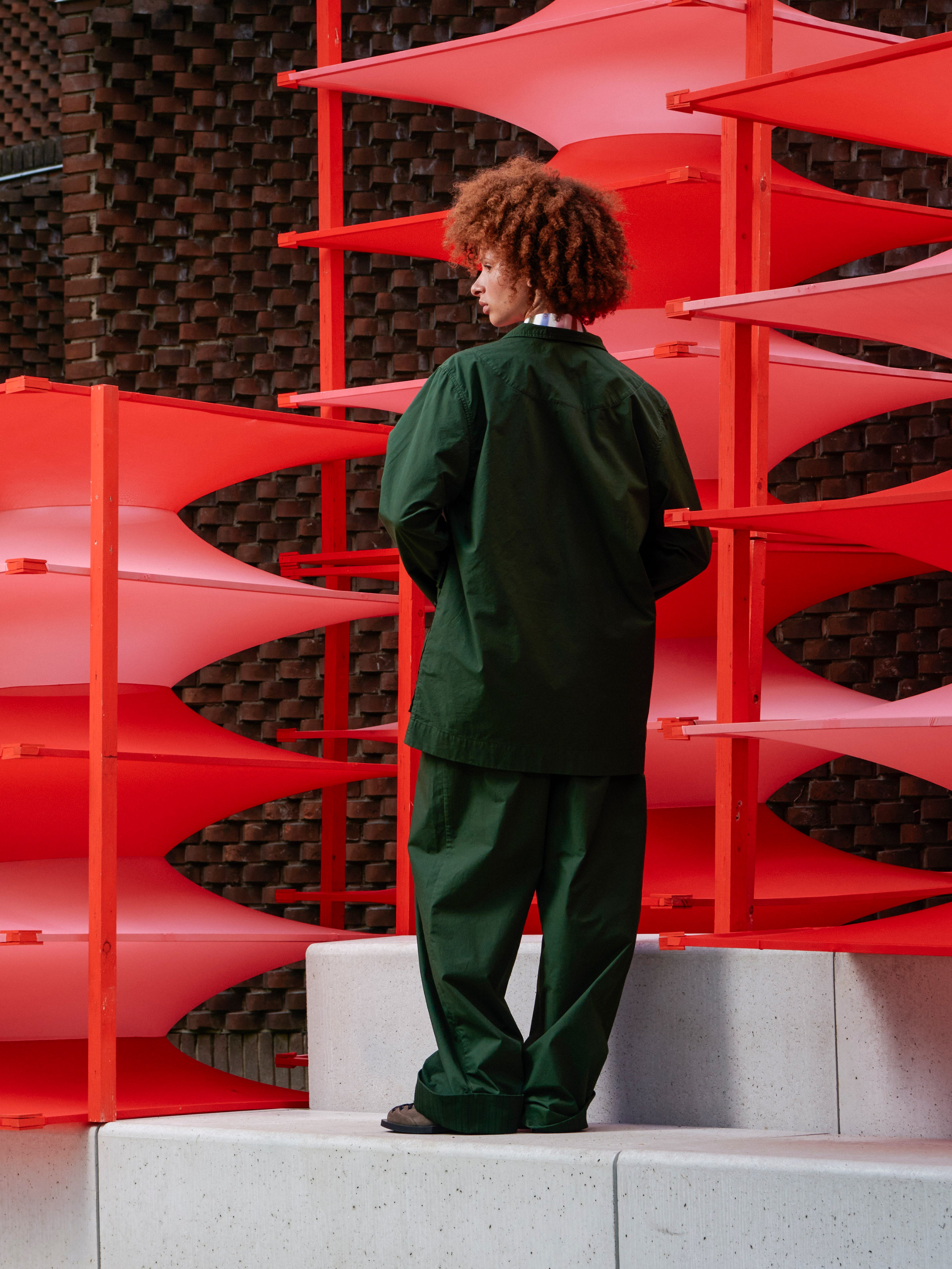 Model wearing the Mid-Air Jacket in Garden Green navy green checked jacket with classic collar and long sleeves, back view – Henrik Vibskov Spring/Summer 2026 Key Collection
