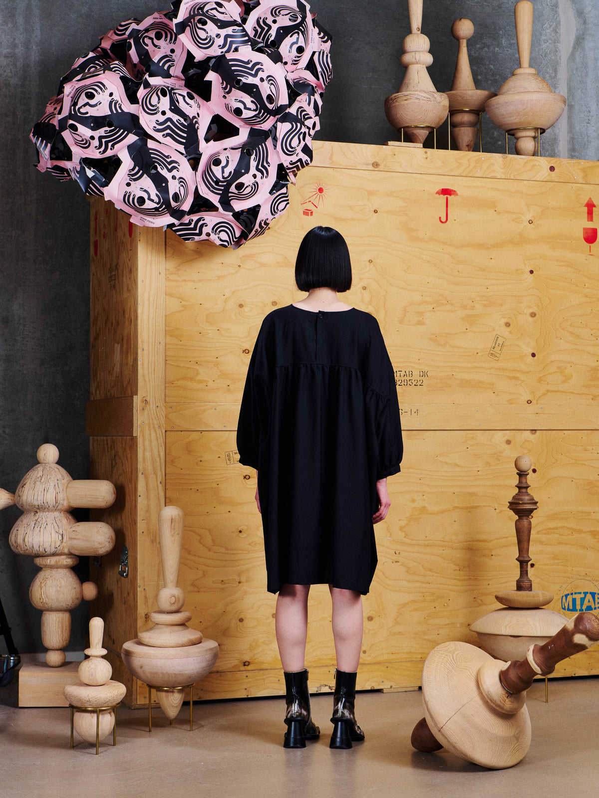 Henrik Vibskov Non Chalant Dress in Black worn back view, showing the loose silhouette, back yoke seam and small button closure at the neckline.