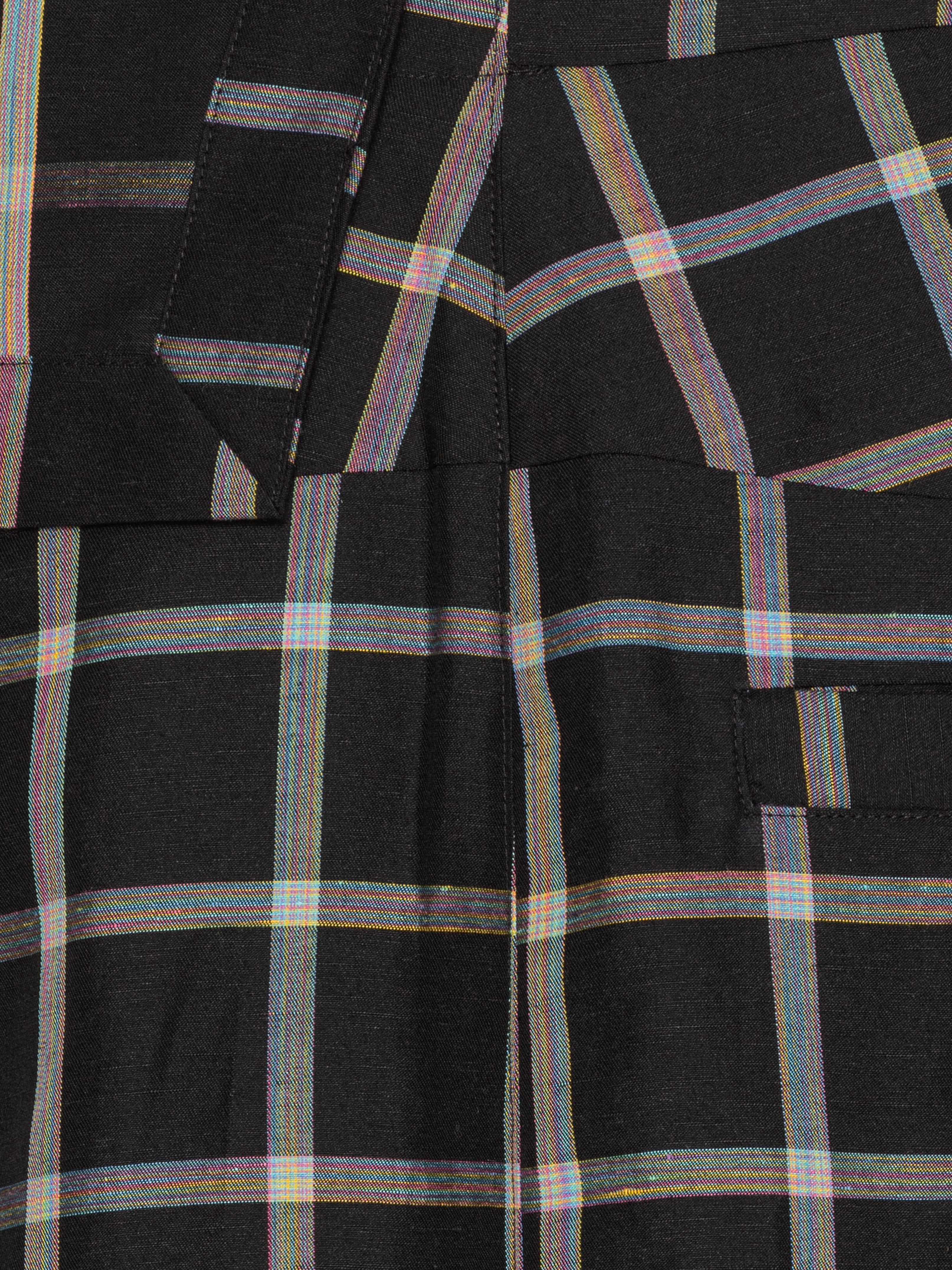 Close-up of the Henrik Vibskov Ocu Skirt in Black Checks, highlighting the check pattern, extra fabric detailing, and texture.