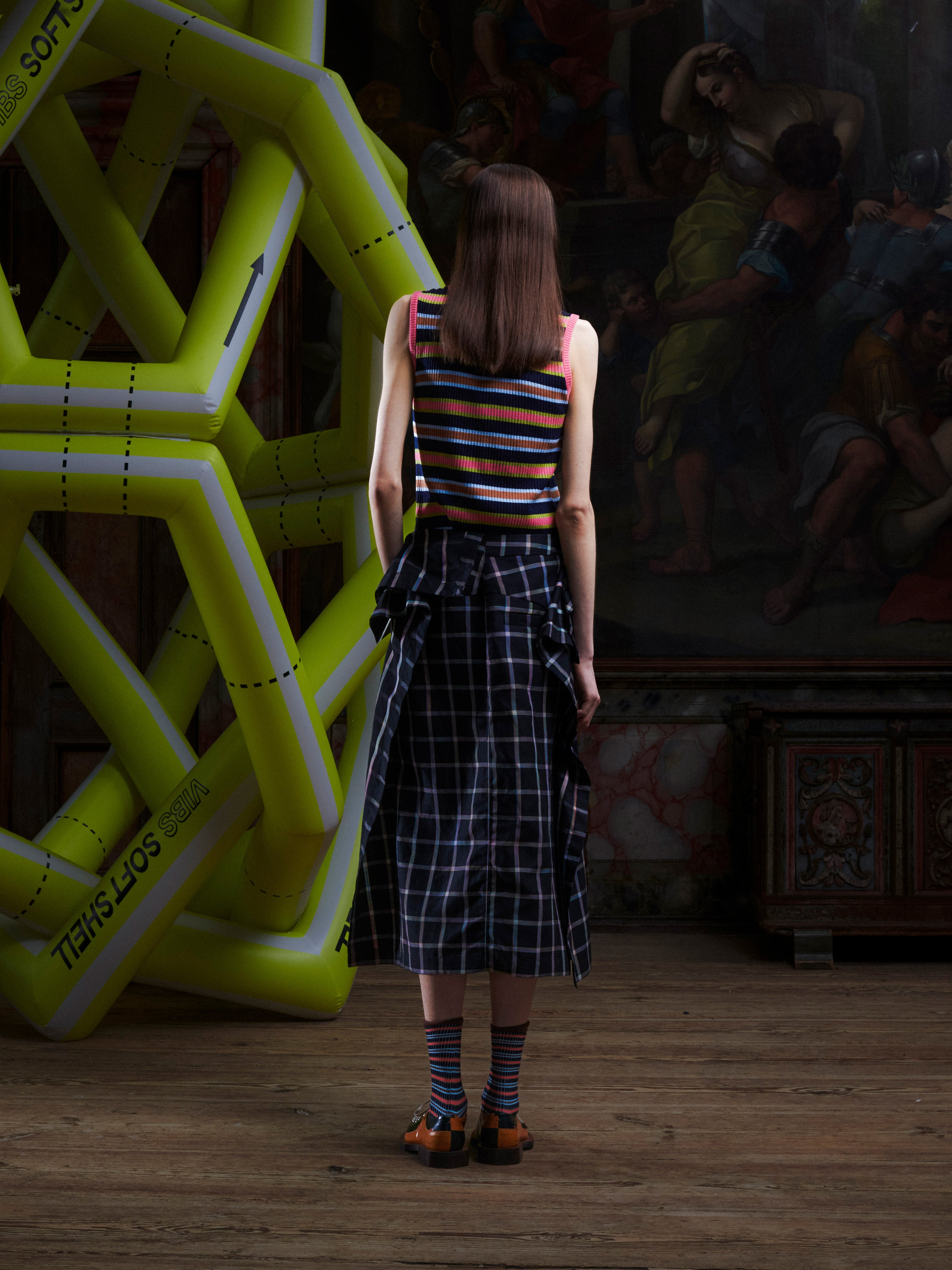Model wearing the Henrik Vibskov Ocu Skirt in Black Checks, back view, showing the straight hem and clean back design.