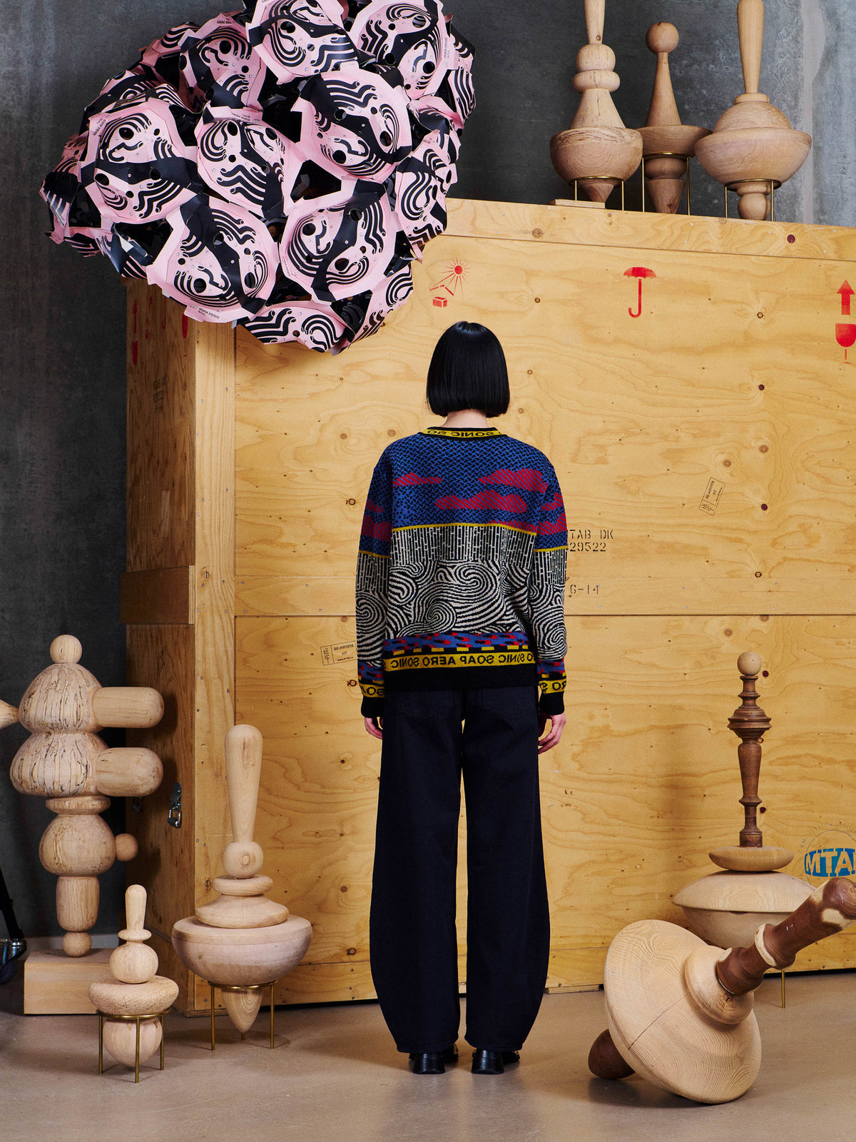 Back view of model wearing Henrik Vibskov Sail Knit Sweat in Stormy Sea, showing the graphic jacquard pattern across the back and ribbed hem.
