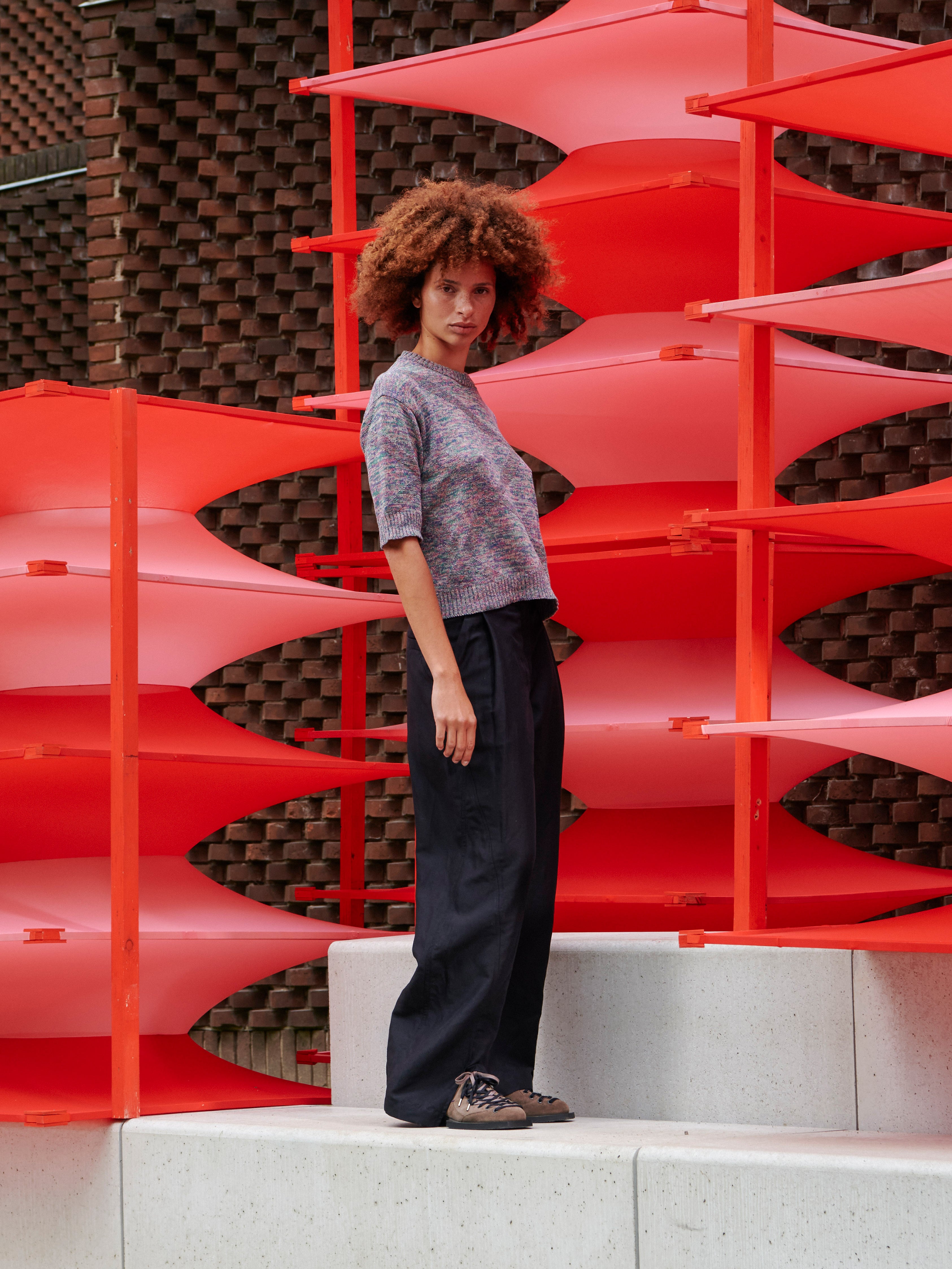 Model wearing the Silk Net Blouse in Multi Papavero mix colour cropped boxy knit with elbow length sleeves and ribbed hems, side view – Henrik Vibskov Spring/Summer 2026 Key Collection