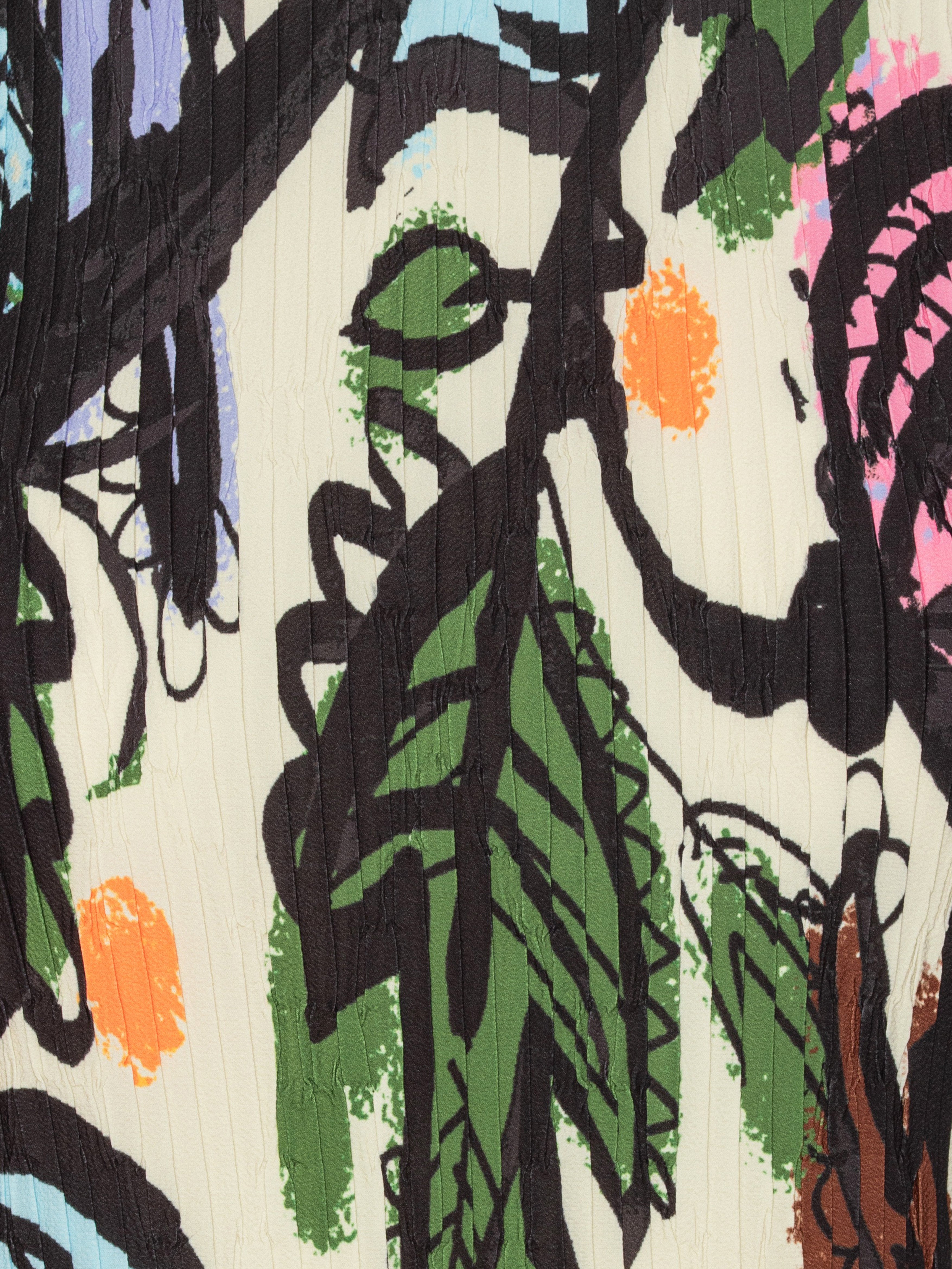 Close-up of colorful top with abstract design with black outlines