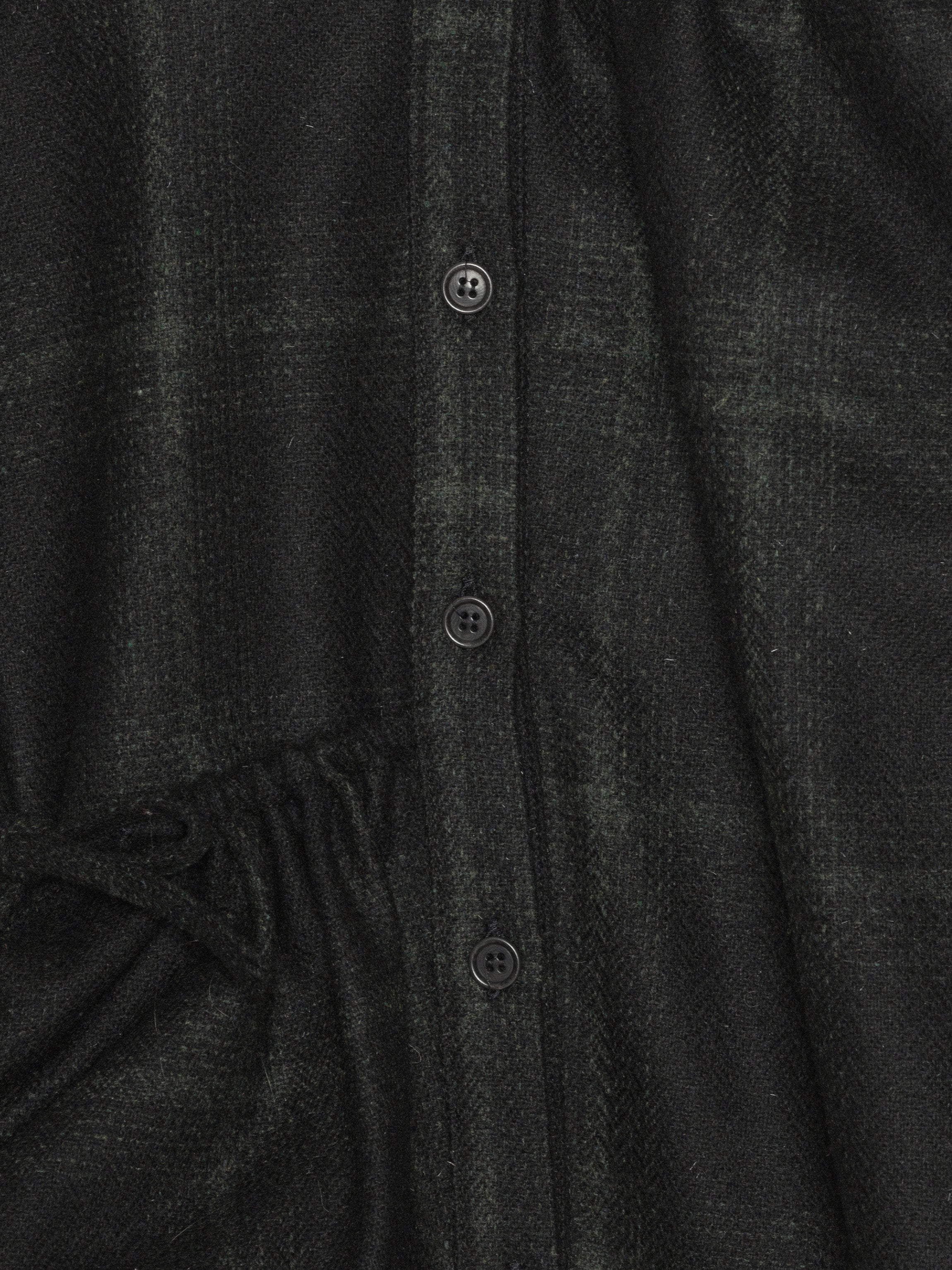 Close-up of a dark gray textured fabric with buttons