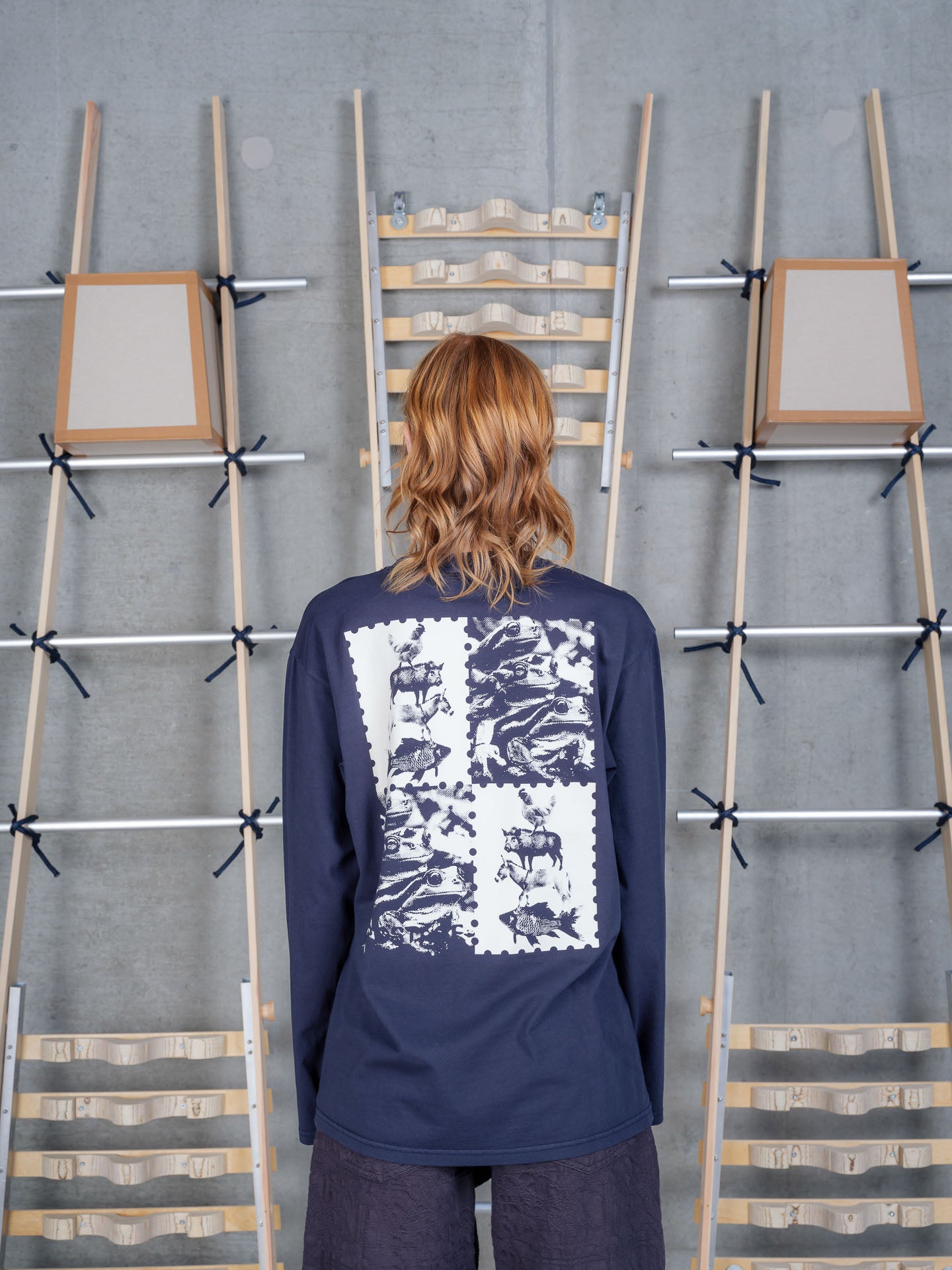 Back view of a female model wearing the Henrik Vibskov Tower Swamp Blouse in Black, highlighting the large off-white graphic print across the back and relaxed silhouette.