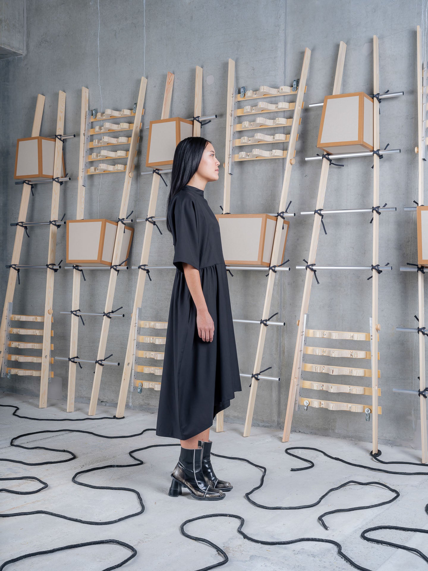Side view of Henrik Vibskov Very Turtle Dress in black showing gathered panels, wide short sleeves and asymmetric hem