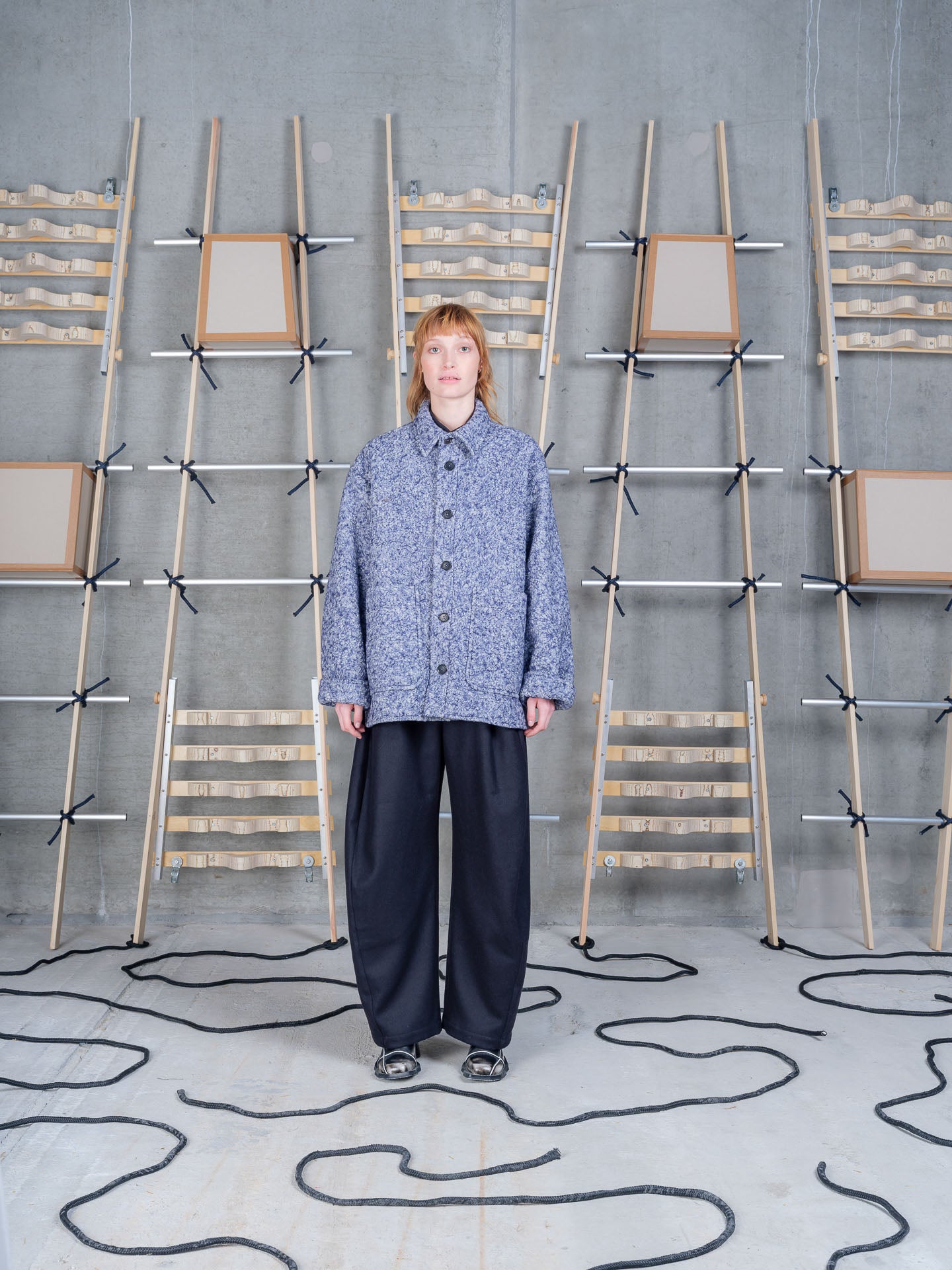 Henrik Vibskov Wheel Jacket in Blue Pebbles worn on model, full-length front view, flecked bouclé wool blend texture, point collar, contrast black button-front fastening