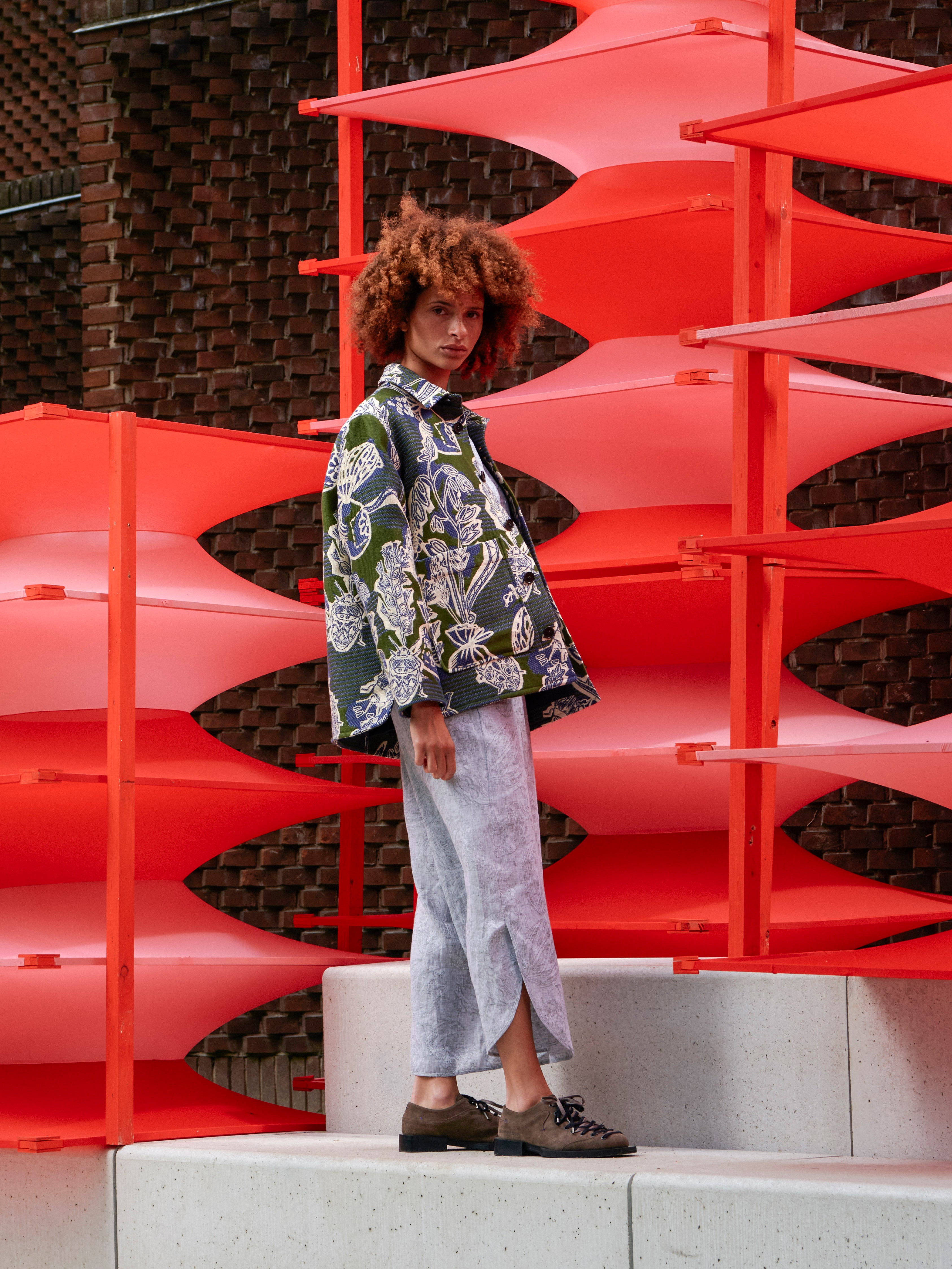 Model wearing the Wheel Jacket in Garden of EEden green blue and white floral boxy jacket with straight hem and long sleeves, side view – Henrik Vibskov Spring/Summer 2026 Key Collection