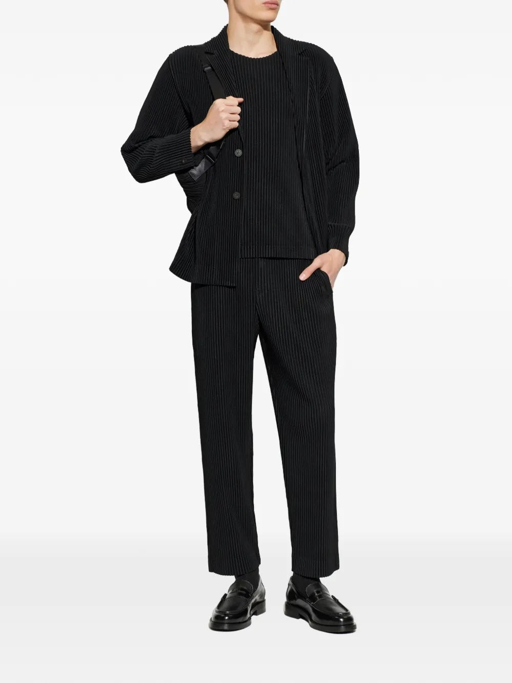 Homme Plissé Issey Miyake April SS26 Basic Jacket black, styled on model head-to-toe with matching pleated trousers and a pleated crewneck, worn with black loafers and a crossbody bag