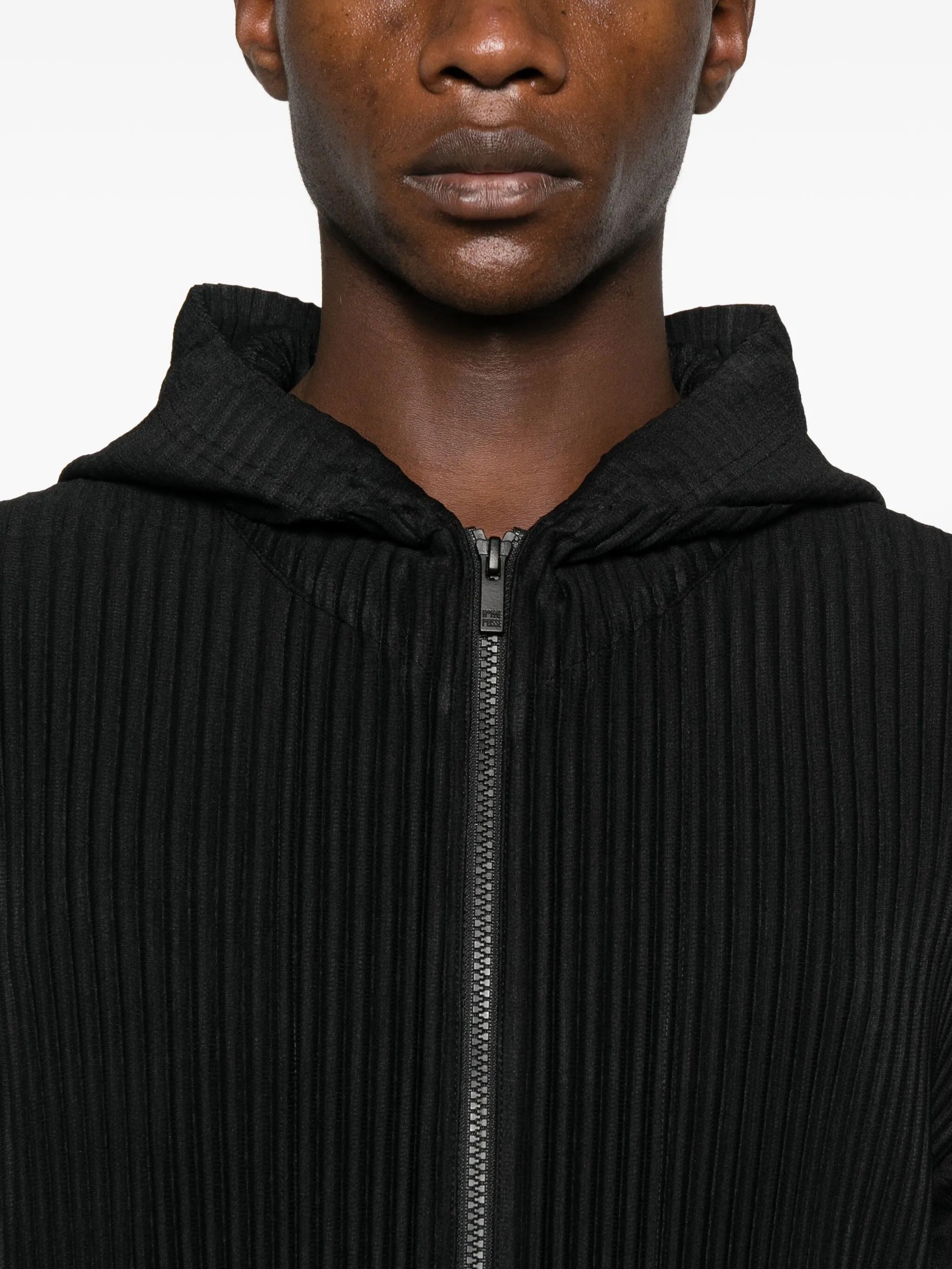 Black ribbed zip-up hoodie worn by a person on a white background