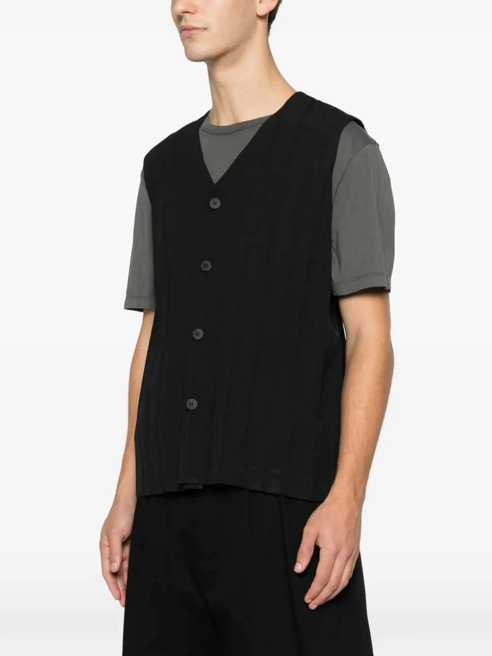 Side view of the black plissé vest with front button closure from Homme Plissé Issey Miyake on a white background.