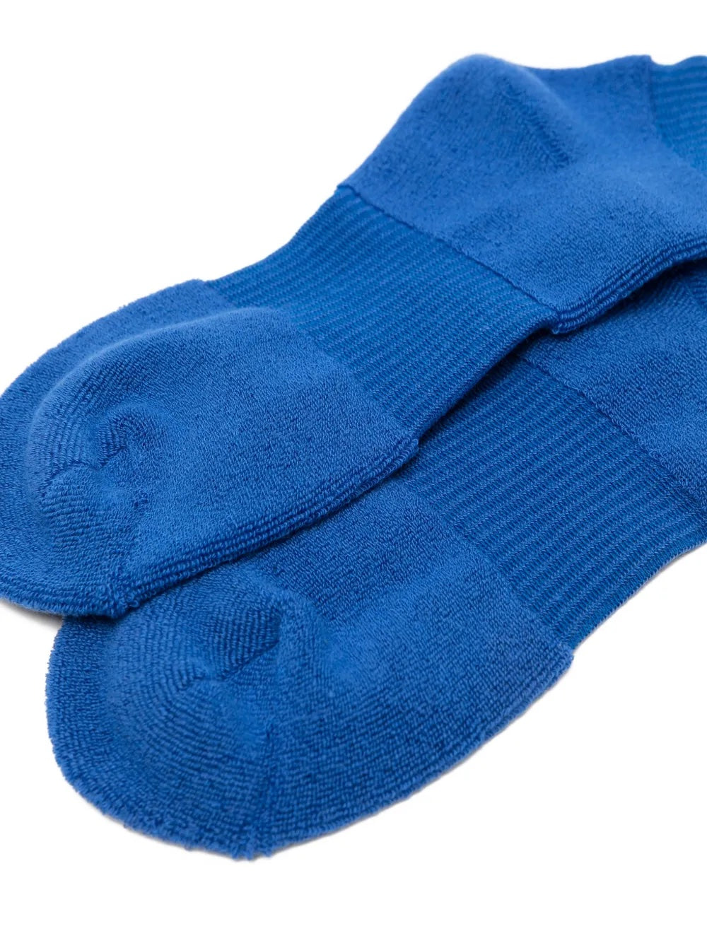 Closeup of the foot section of Issey Miyake October AW25 Pumped Socks in blue, showing ribbed knit structure and refined finish.