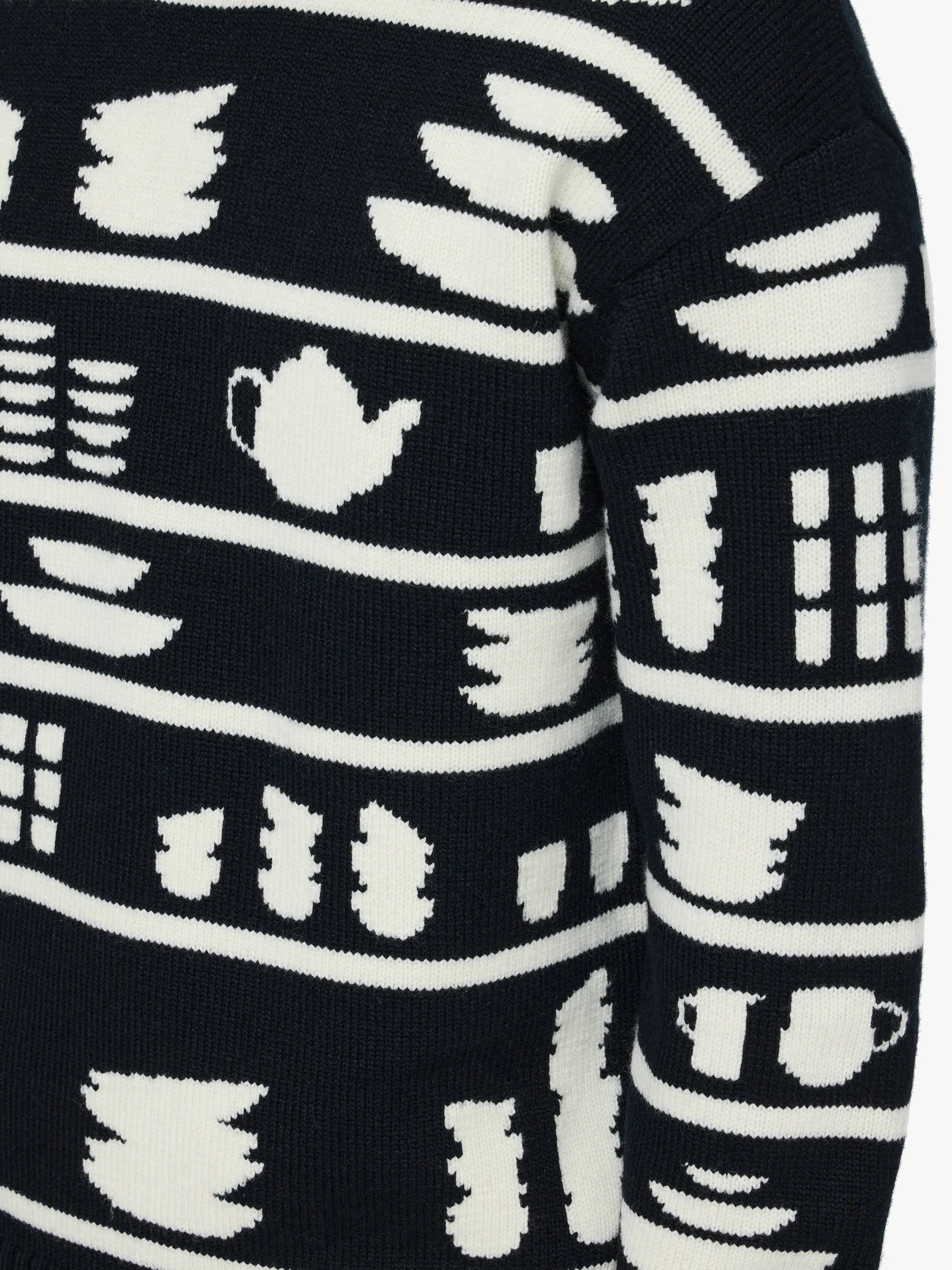Black sweater with white tea-themed pattern
