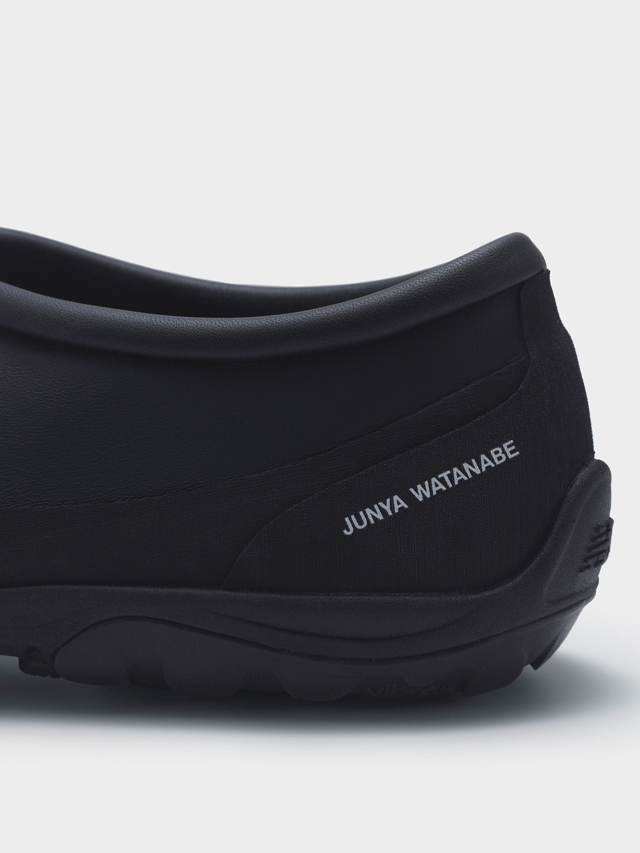 Junya Watanabe x New Balance MT10T sneakers in black, close-up of heel with Junya Watanabe logo on textile panel